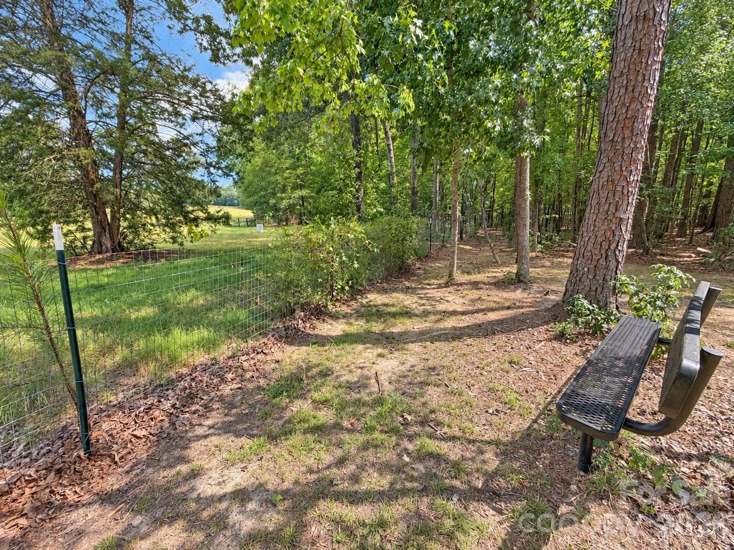 bench at the back of the property for sitting to watch the neighboring farm animals - 9201 Providence Road S, Waxhaw