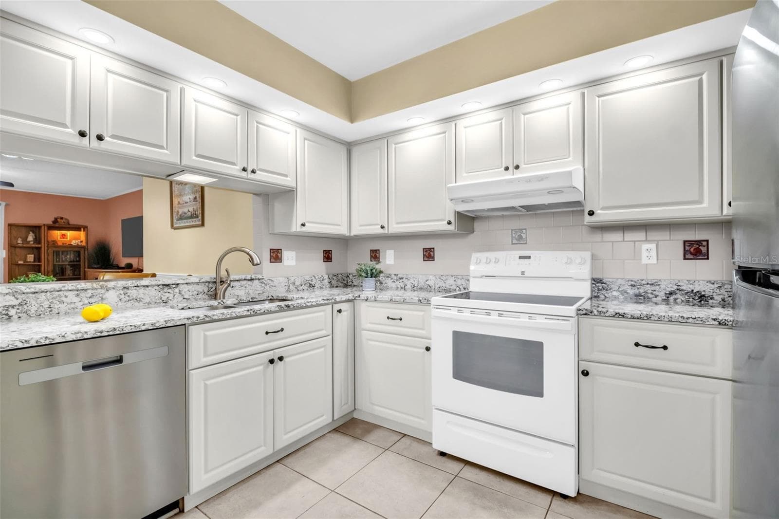 Granite countertops, solid-wood cabinetry, and recessed lighting~ - 2700 NEBRASKA AVE #5-205, PALM HARBOR