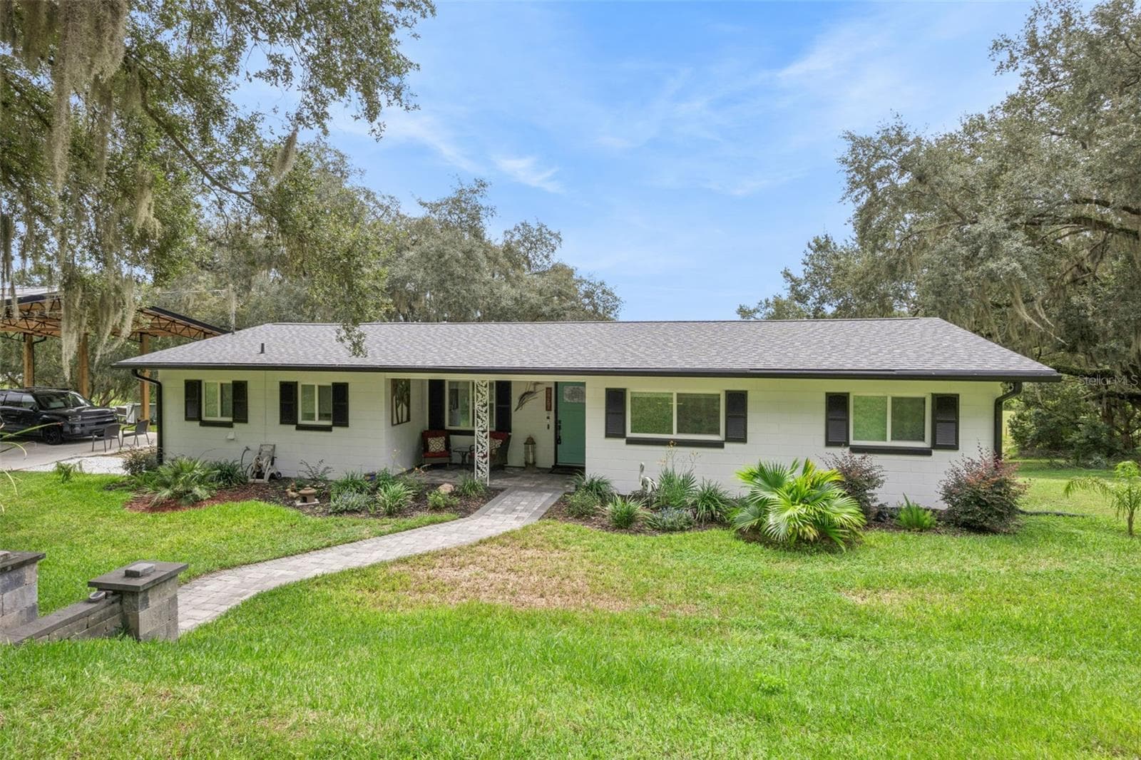 Welcome to 1476 Spring Lake Rd: a beautifully updated home with custom paver walkway, professional landscaping, and an inviting covered front entry in sought-after Fruitland Park, FL. - 1476 SPRING LAKE RD, FRUITLAND PARK
