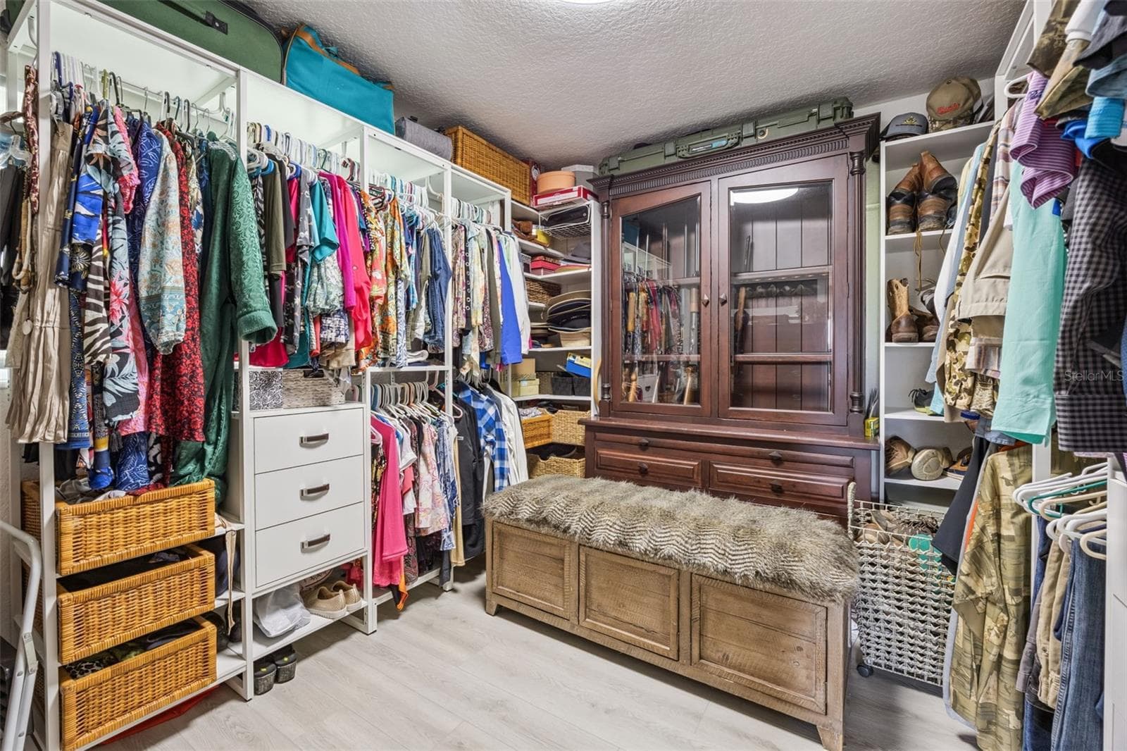 Expansive walk-in closet with built-in organizers, shelving, and room for an entire wardrobe. - 1476 SPRING LAKE RD, FRUITLAND PARK