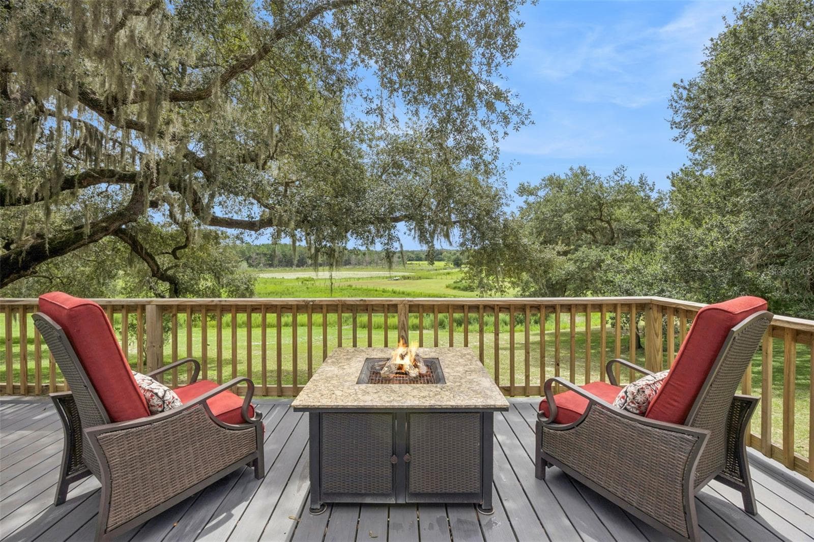 Imagine evenings around the fire pit on the elevated deck, soaking in panoramic views of green pastures framed by moss-draped oaks. - 1476 SPRING LAKE RD, FRUITLAND PARK