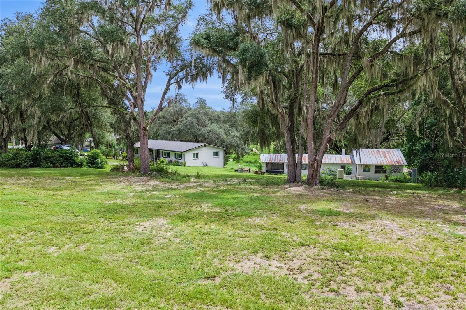 Aerial perspective highlighting the property's generous acreage and the natural beauty of the Fruitland Park countryside. - 1476 SPRING LAKE RD, FRUITLAND PARK
