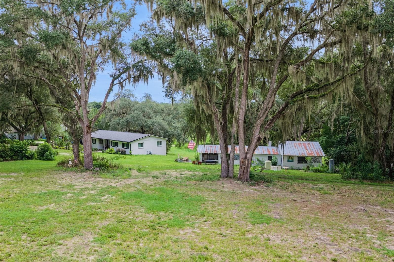 From above, the full picture unfolds: a private homestead with pastoral views in every direction. - 1476 SPRING LAKE RD, FRUITLAND PARK