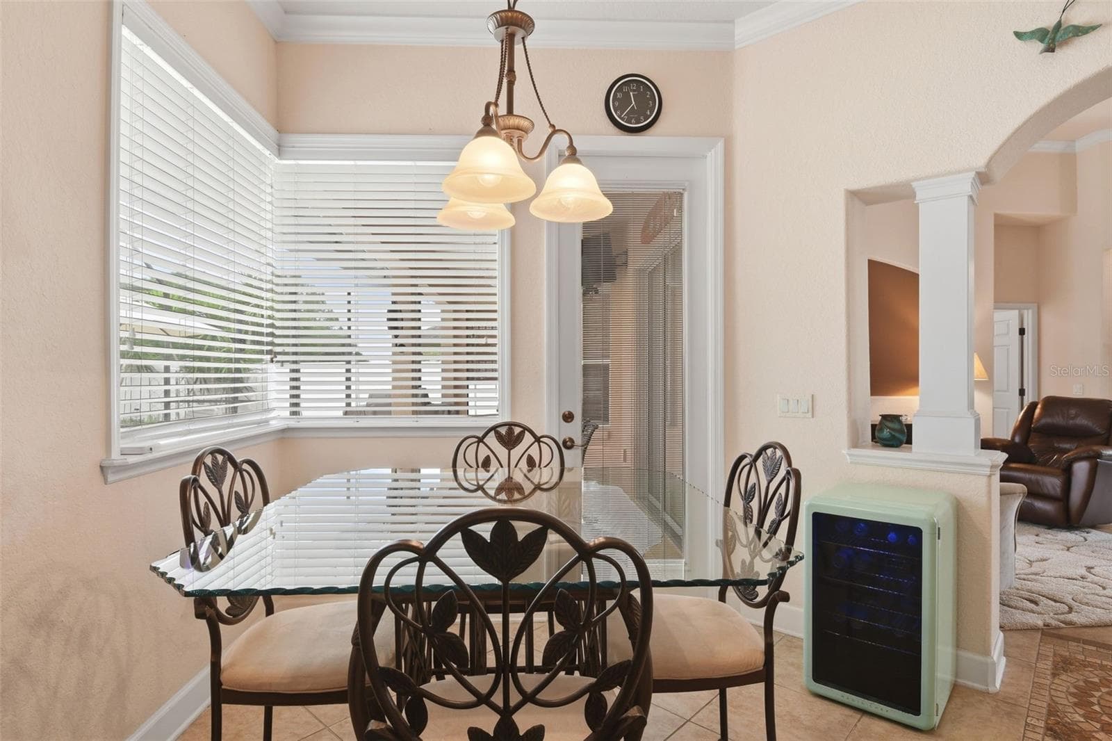 Breakfast Nook – Bright casual dining area with wraparound windows, a decorative light fixture, and an open connection to the adjoining living space. - 114 VIOLA DR, AUBURNDALE