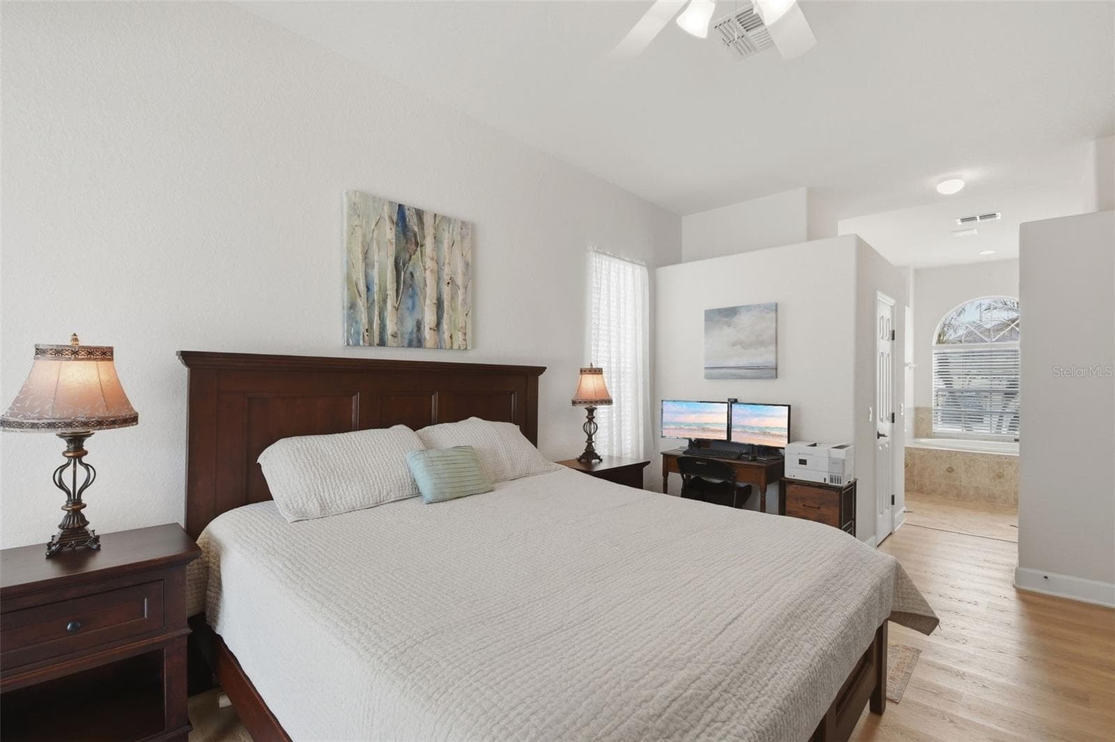 Primary Bedroom – Another angle of the primary suite highlights its generous proportions, high ceiling, natural light, and convenient connection to the adjoining bath area. - 114 VIOLA DR, AUBURNDALE