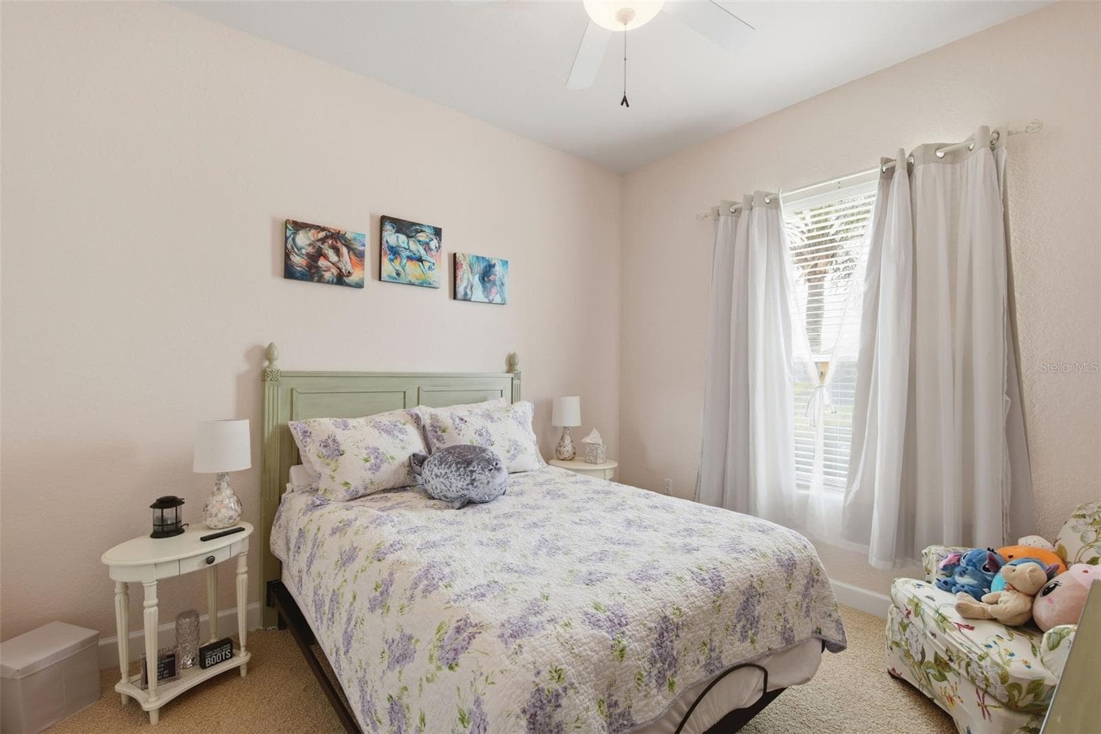 Bedroom – Comfortable secondary bedroom with neutral finishes, carpeting, a ceiling fan, and a large window that brings in natural light. - 114 VIOLA DR, AUBURNDALE