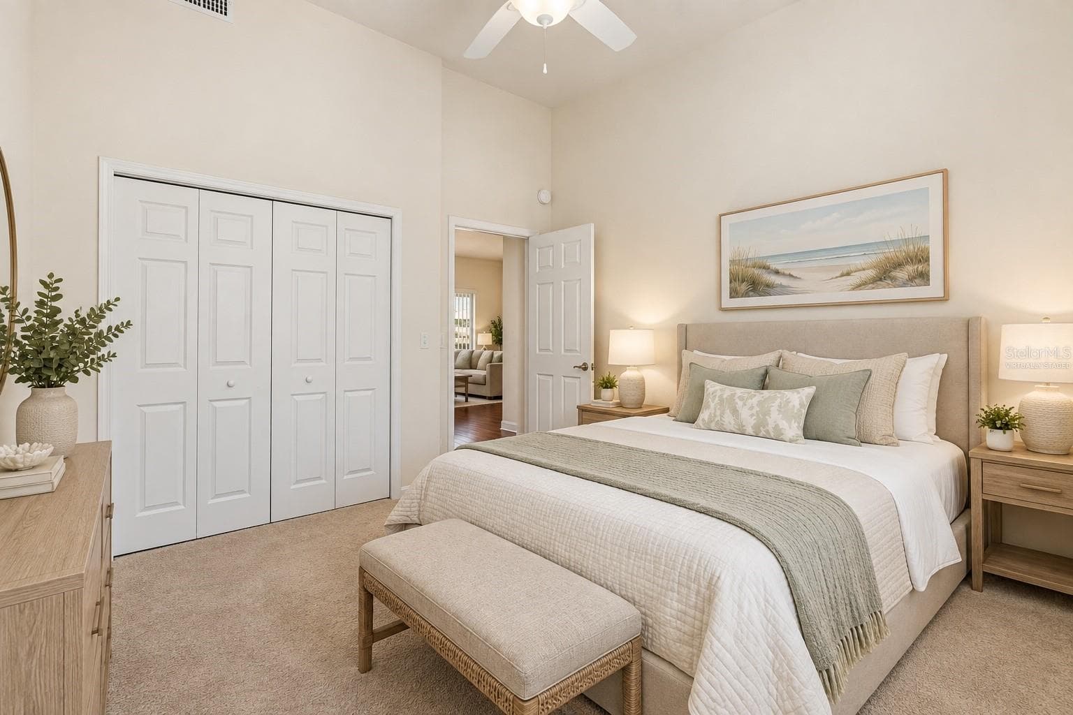 Bedroom – Virtually staged to illustrate furnishing possibilities, this bright bedroom features a vaulted ceiling with ceiling fan, neutral carpeting, and a generous double-door closet. - 114 VIOLA DR, AUBURNDALE