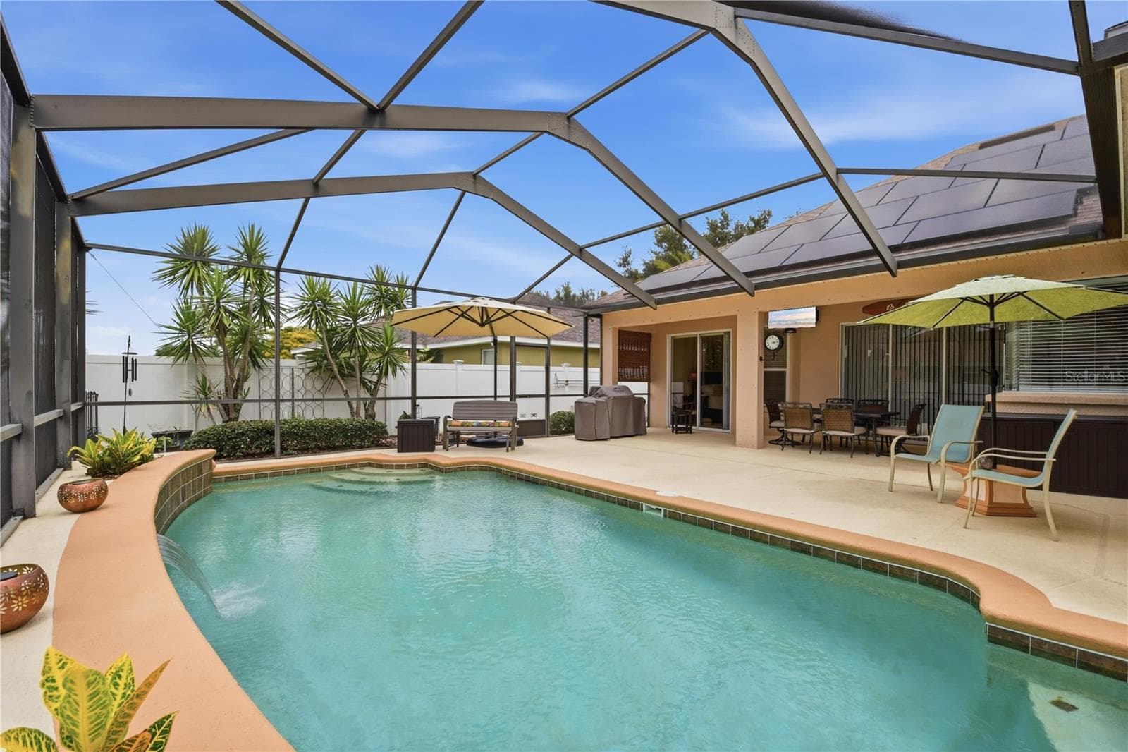 Pool & Lanai – A second pool view highlights the screened enclosure, expansive deck space, covered lanai, and multiple areas for outdoor seating and entertaining. - 114 VIOLA DR, AUBURNDALE