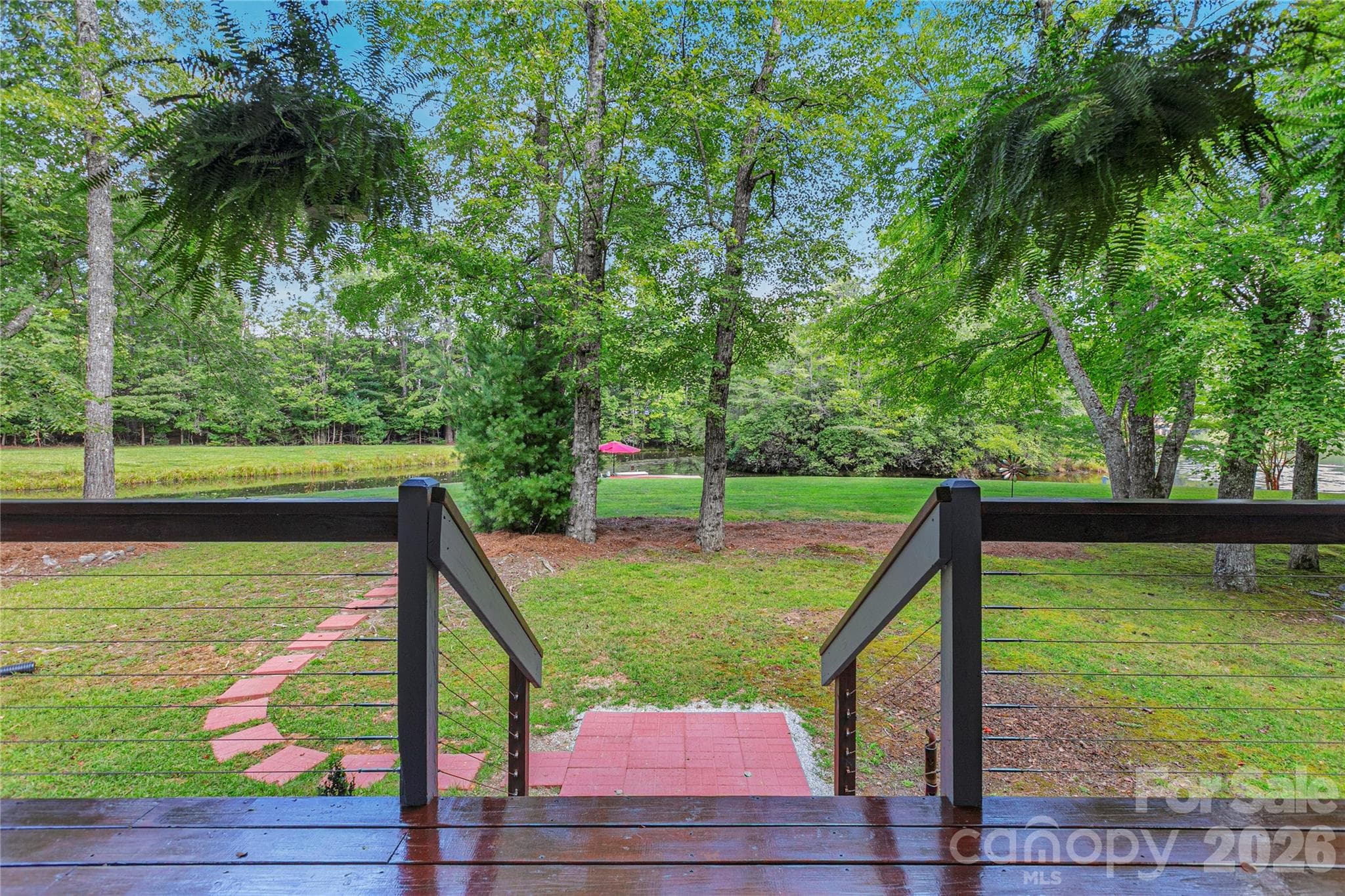 View of the lake with pavers to take you towards the dock. - 111 Kanunu Court, Brevard