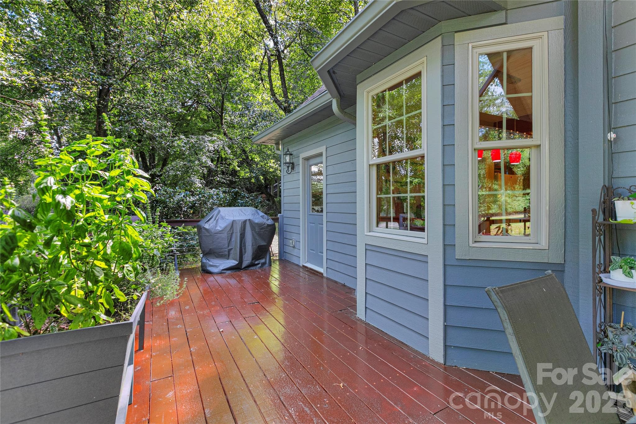 Deck next to the covered deck where the gas grill is waiting for your next barbeque. - 111 Kanunu Court, Brevard