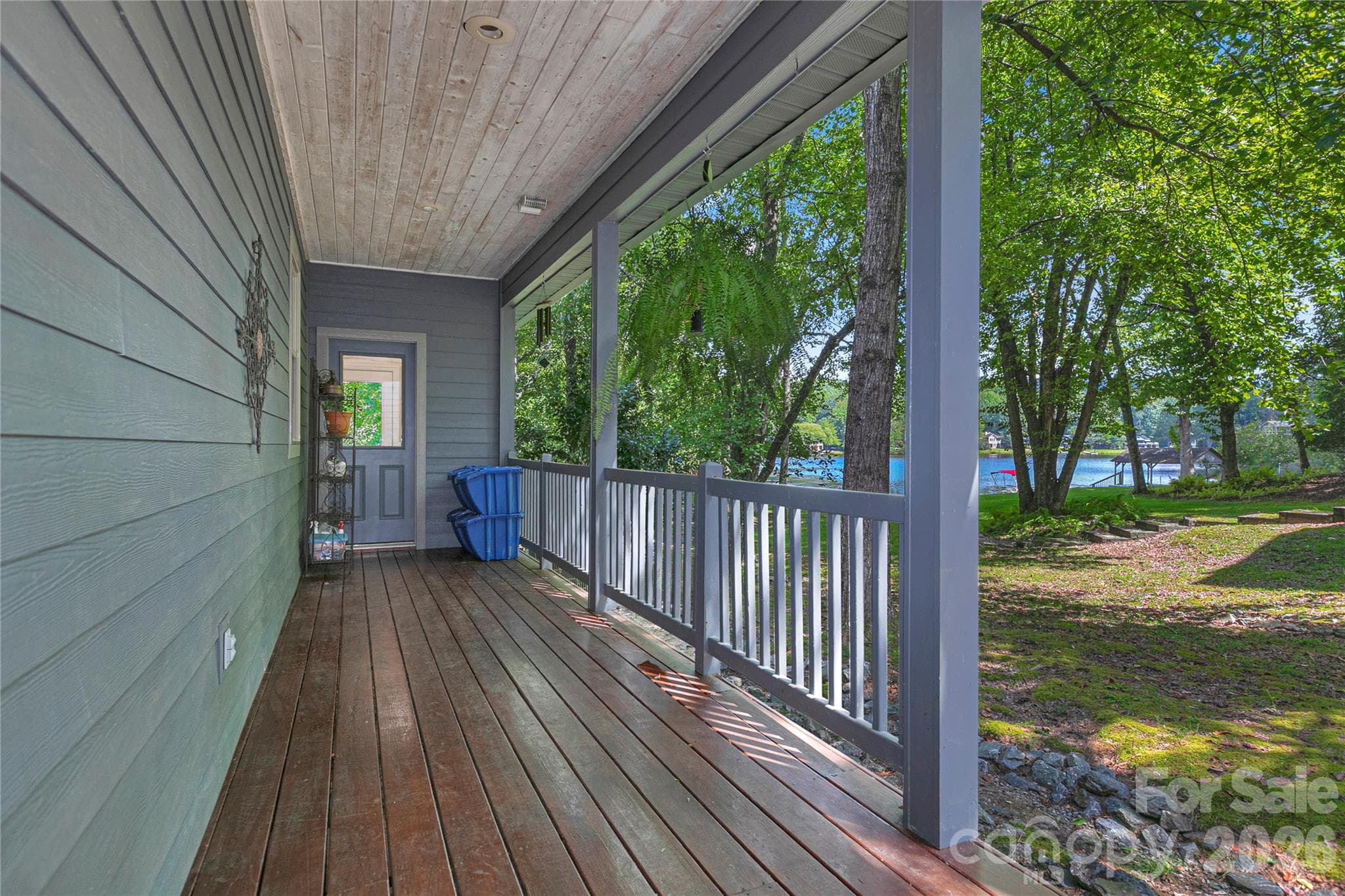 The Covered Side Porch connects the Utility Room to the Detached Garage - 111 Kanunu Court, Brevard