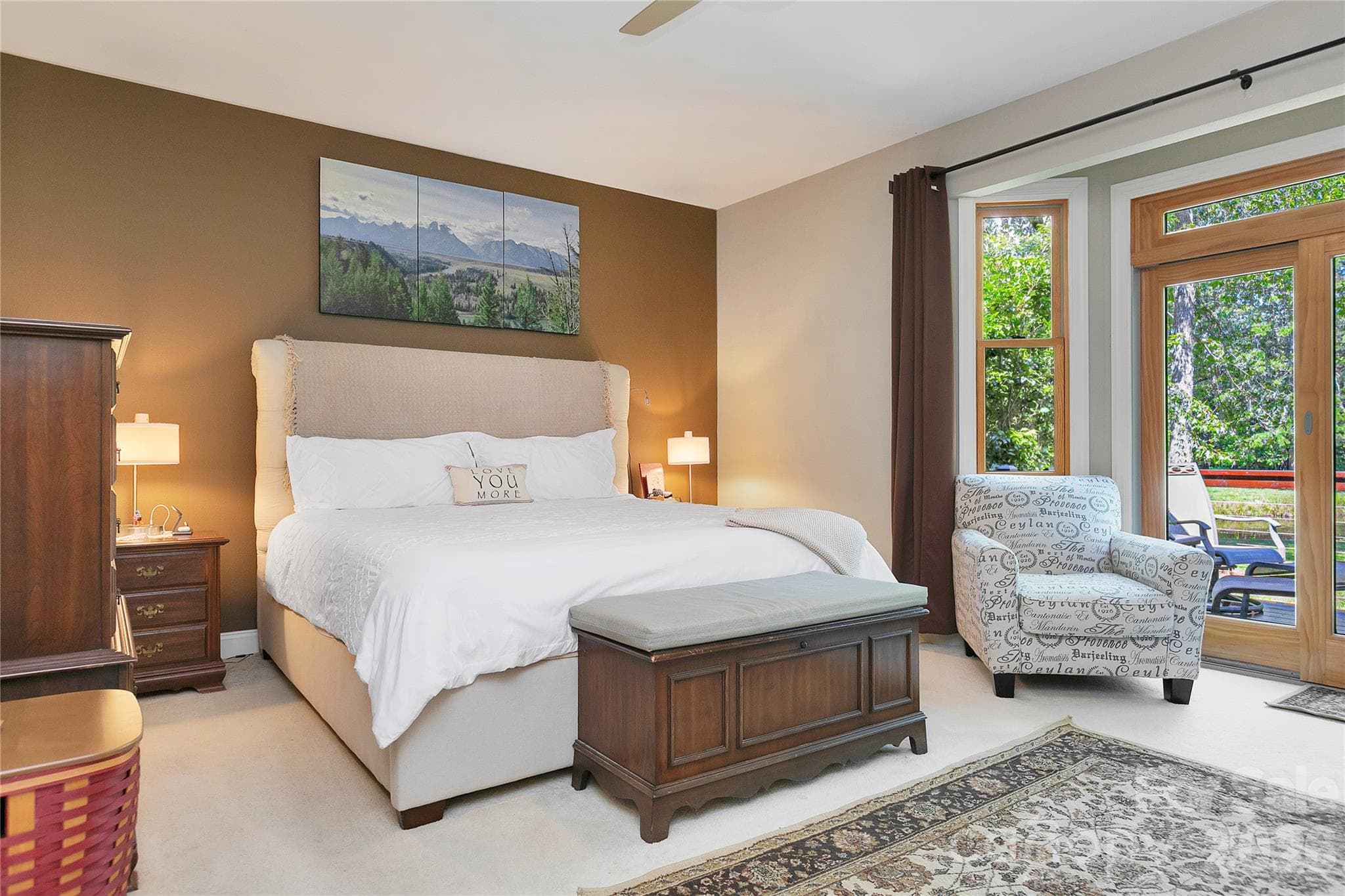 The Primary Bedroom is behind the Great Room Fireplace. You can lie in bed to view the sunrise over the lake. - 111 Kanunu Court, Brevard