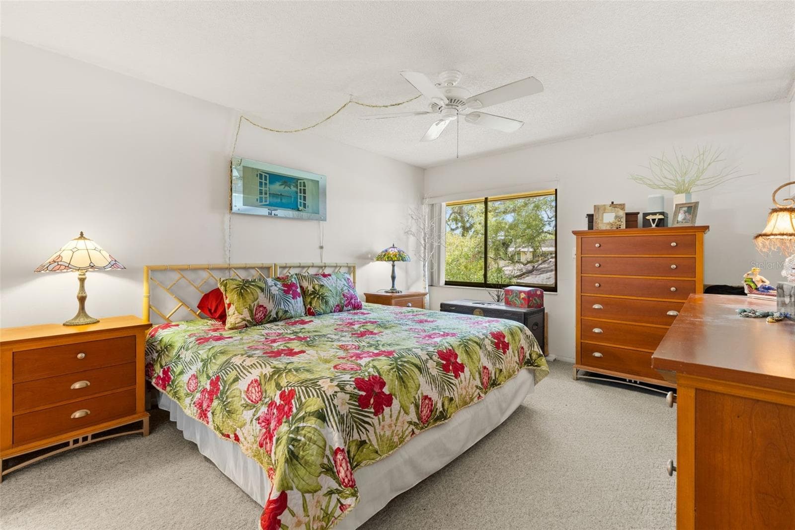 The primary bedroom measures approximately 11'10" x 13'7", with neutral carpeting, a ceiling fan and a wide window overlooking the trees. The room has enough wall space for a full bedroom set without feeling crowded. - 12300 VONN RD #3204, LARGO