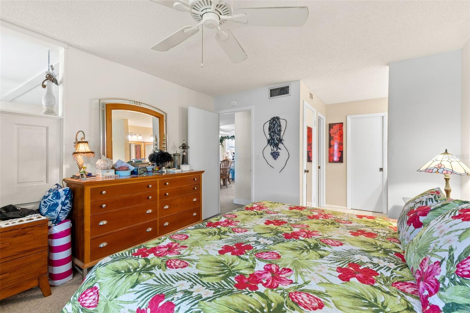 The primary bedroom offers generous space for a full bedroom set, with neutral carpeting, a ceiling fan and direct access to the bath and walk-in closet area. - 12300 VONN RD #3204, LARGO