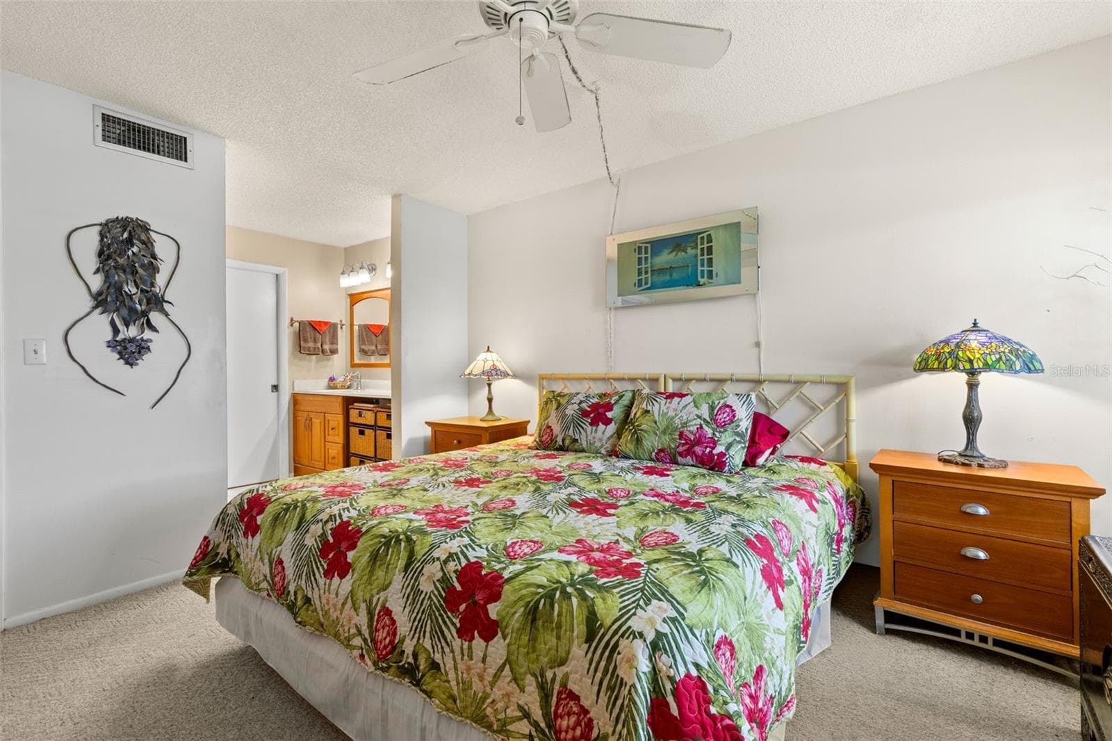 The primary bedroom connects directly to its ensuite bath, with neutral carpeting, a ceiling fan and enough room for a substantial bedroom set without feeling tight. - 12300 VONN RD #3204, LARGO