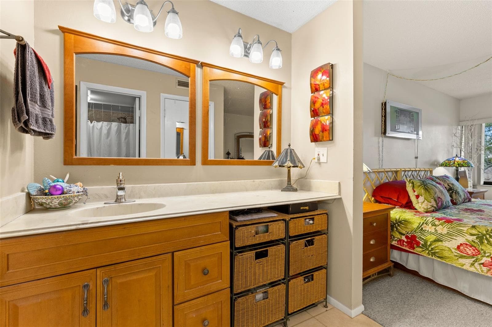The primary bath includes a long vanity with generous counter space, dual mirrors and a separate makeup area with room for seating. - 12300 VONN RD #3204, LARGO