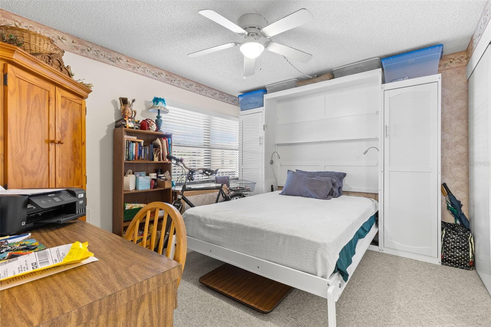Bedroom 2 measures approximately 11'7" x 10'7", with neutral carpeting, a ceiling fan and a wide window bringing in natural light. The room also has direct access to its own bath, giving it a useful degree of separation from the primary suite. - 12300 VONN RD #3204, LARGO
