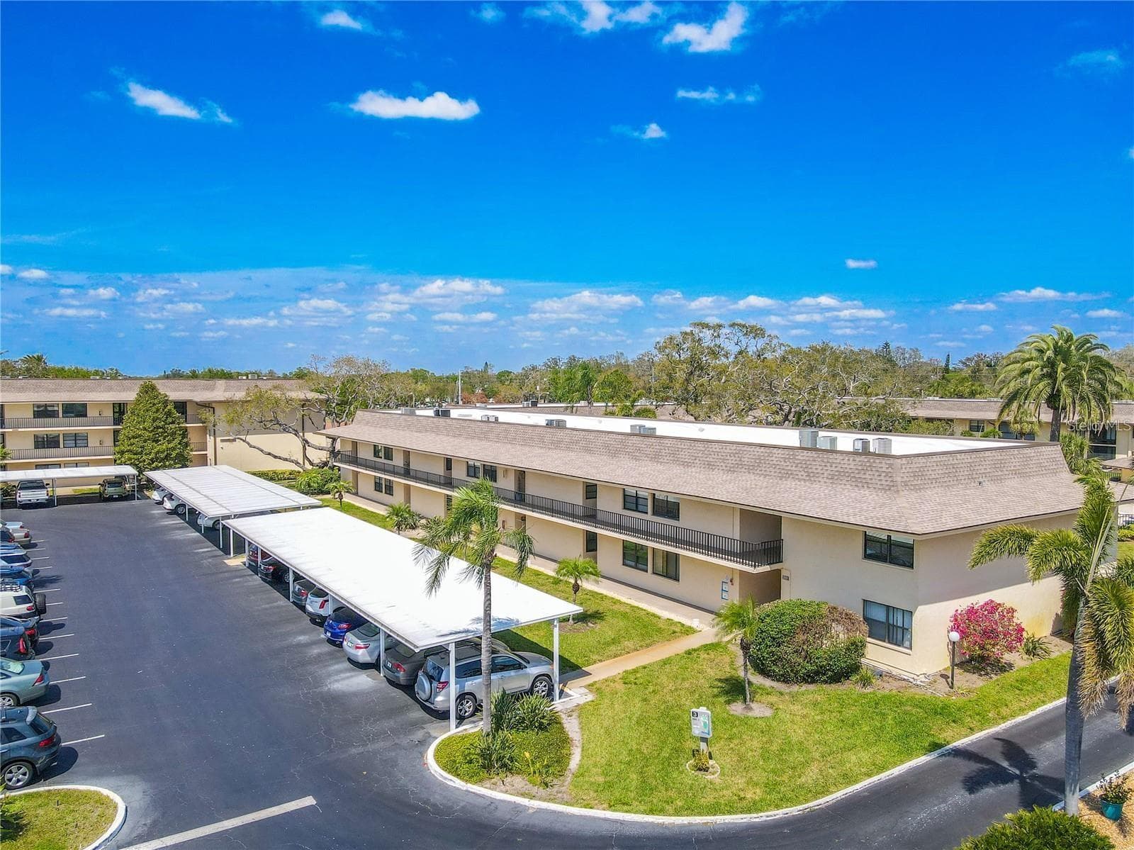 Covered assigned parking runs alongside Building 3, with additional guest parking nearby and landscaped walkways connecting the building to the rest of the community. - 12300 VONN RD #3204, LARGO