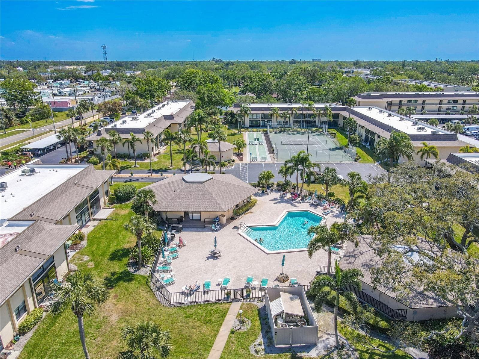 The community pool is surrounded by a broad deck with plenty of seating, while tennis and other court amenities sit just beyond, all grouped together in the heart of Villas de Golf. - 12300 VONN RD #3204, LARGO