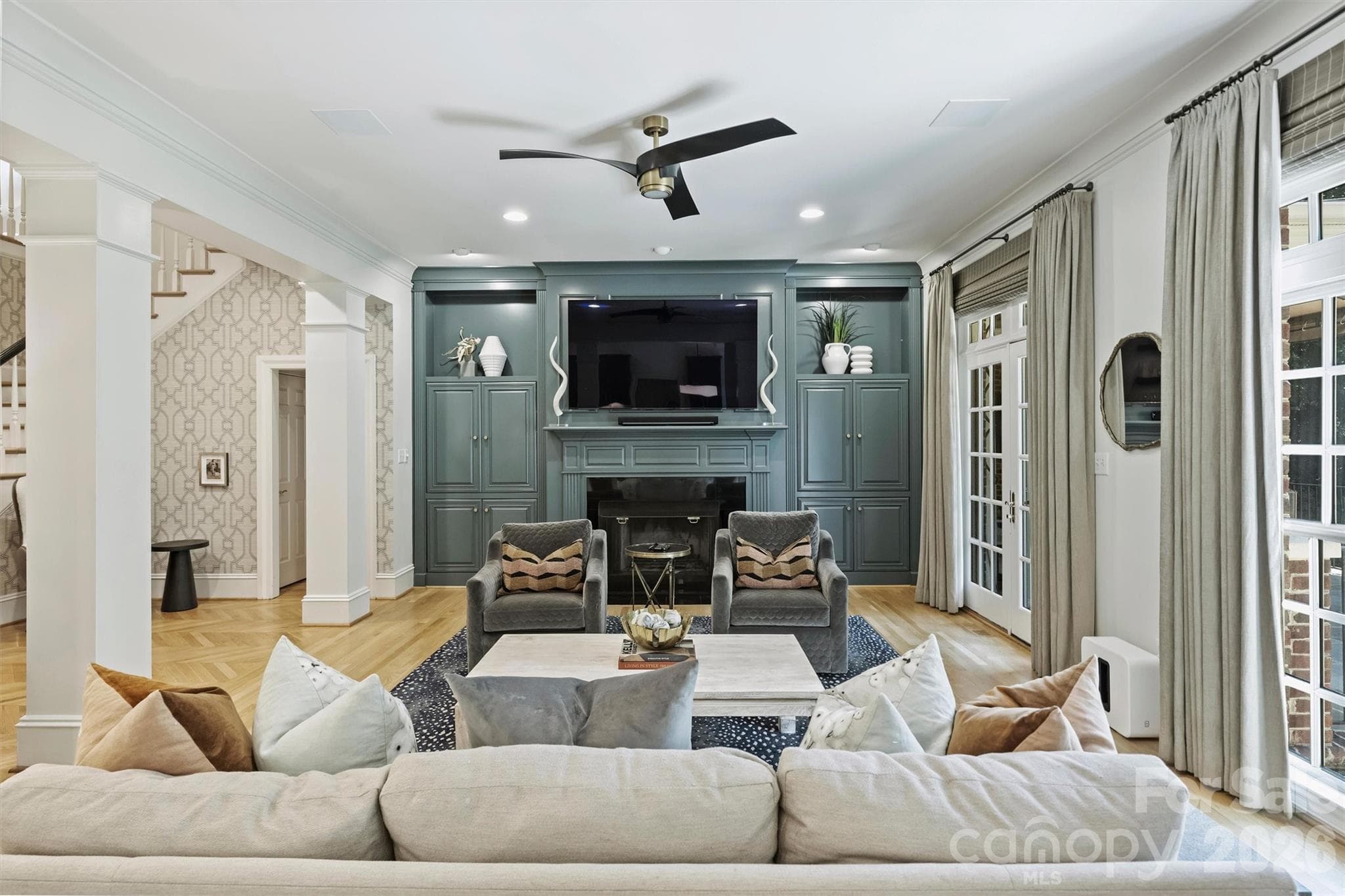 Family Room with built-ins, dry bar, and French doors to the back porch. - 2115 Foxcroft Woods Lane, Charlotte