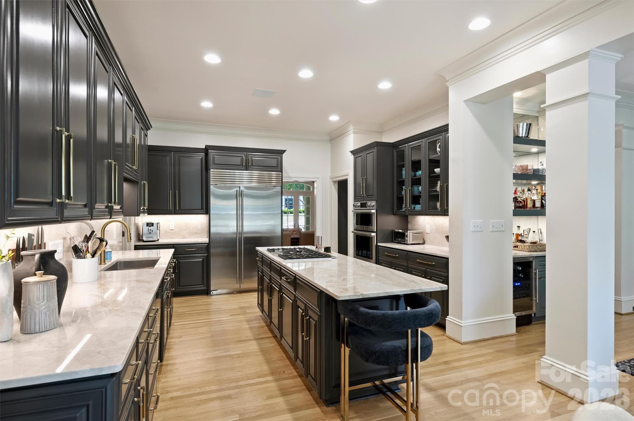 Chef's Kitchen updated with quartzite countertops, high end stainless steel appliances and cabinets refreshed in Iron Ore with new gold hardware. - 2115 Foxcroft Woods Lane, Charlotte