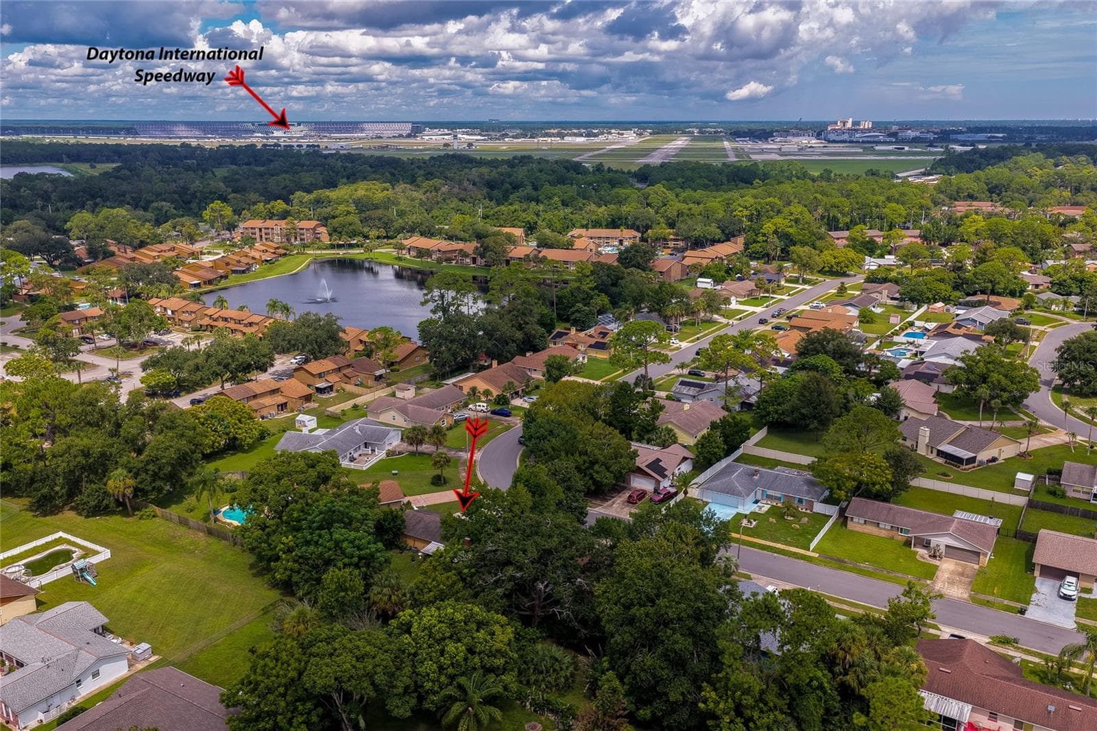 Elevated aerial view pointing out the property location relative to nearby landmarks, including Daytona International Speedway in the background. - 146 WESTWOOD DR, DAYTONA BEACH