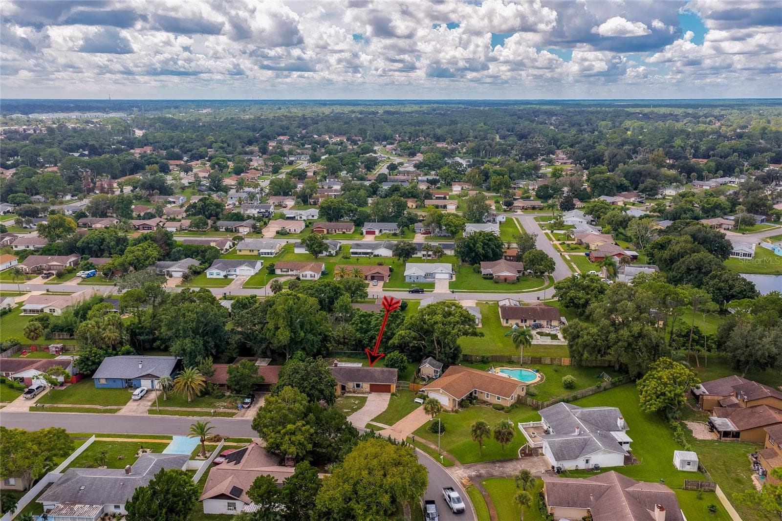 Wide neighborhood aerial view highlighting the home's location among surrounding residential streets and greenery. - 146 WESTWOOD DR, DAYTONA BEACH