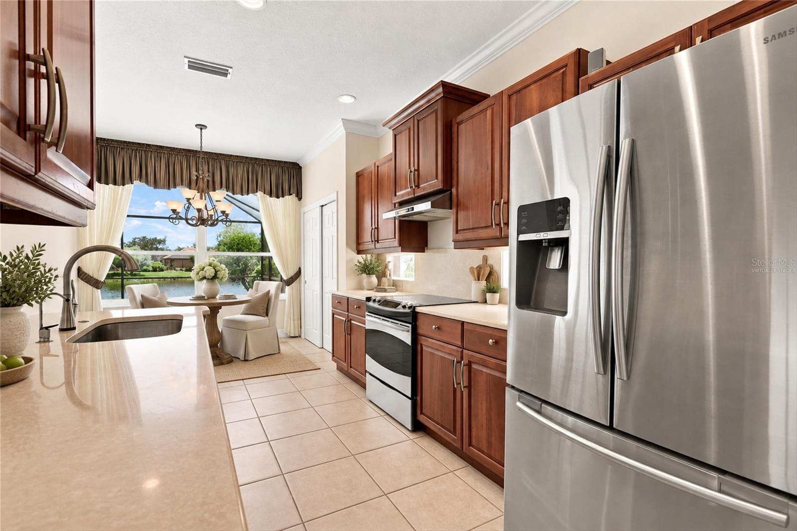 Kitchen with virtually staged dinette set - 1328 THORNAPPLE DR, OSPREY