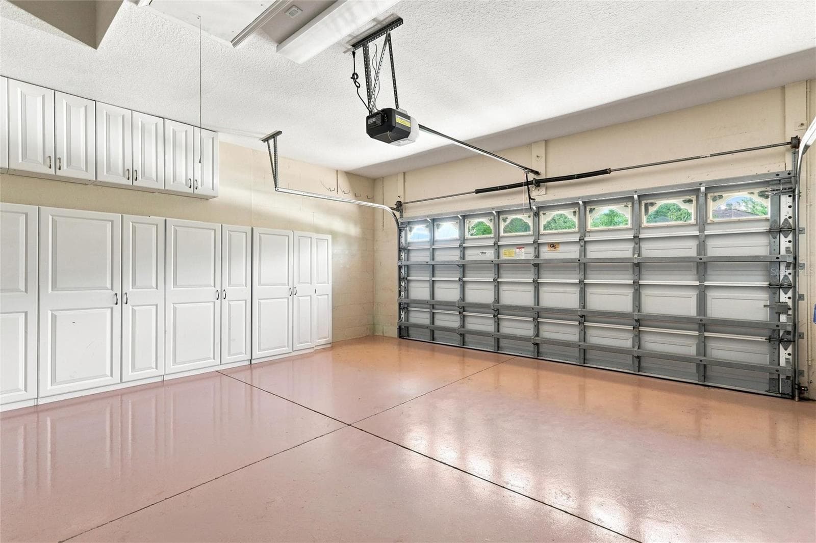 2 car garage with ample storage cabinets - 1328 THORNAPPLE DR, OSPREY