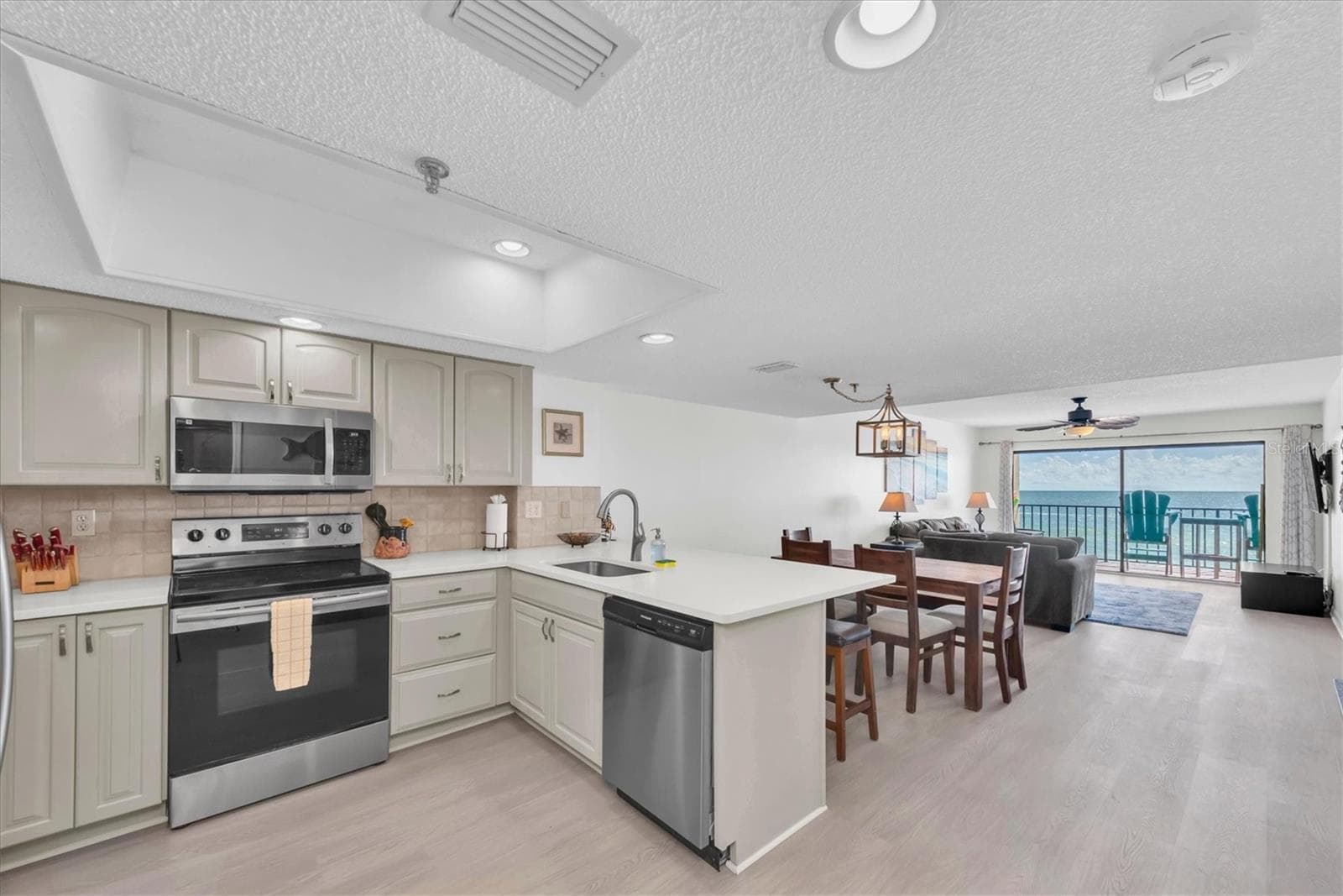Kitchen dinging and living area - 14710 GULF BLVD #206, MADEIRA BEACH