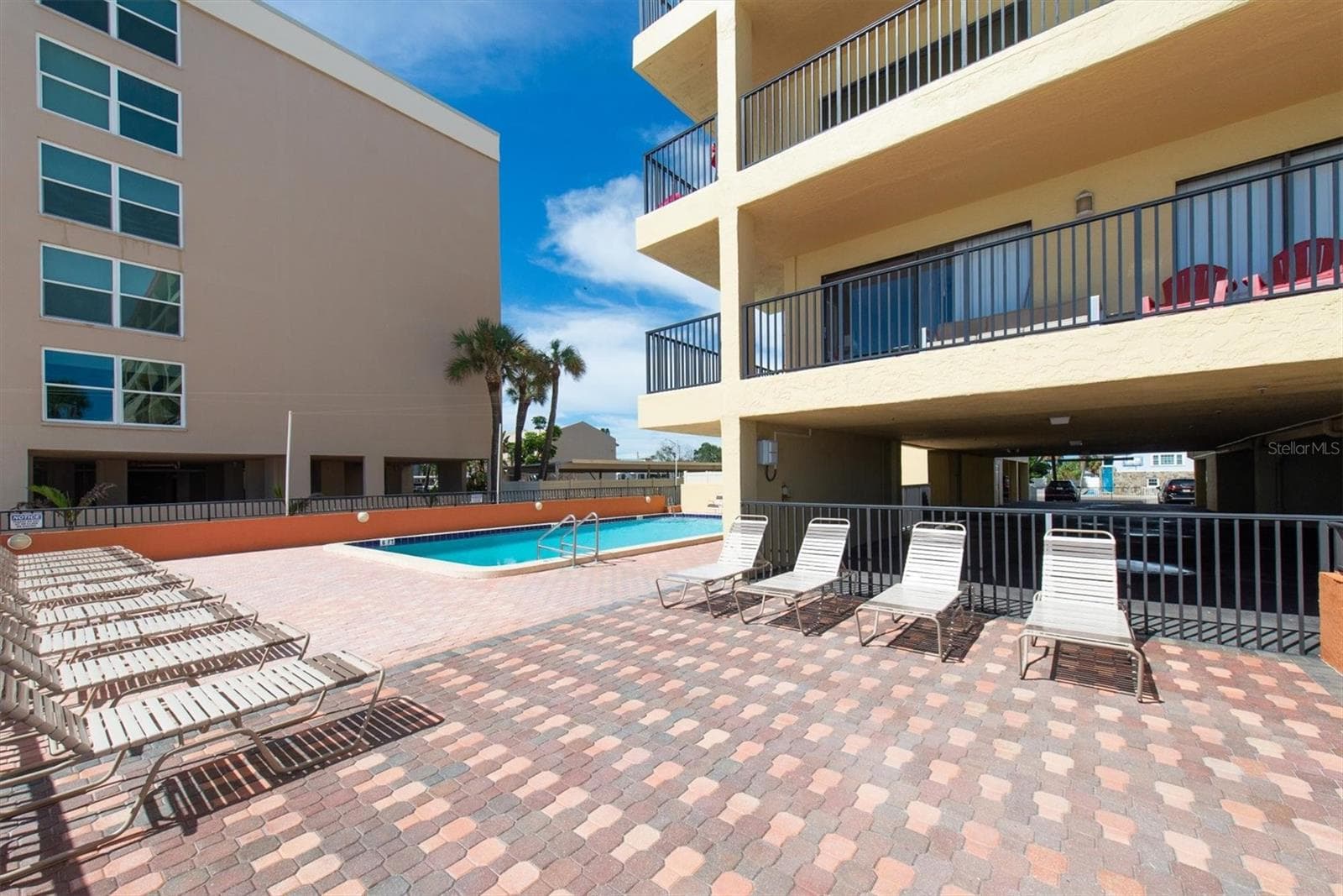 Plenty of seating around the pool - 14710 GULF BLVD #206, MADEIRA BEACH