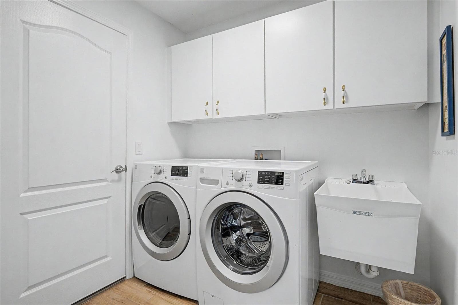 Inside laundry room with utility sink and built in for storage - 12027 FERN TERRACE CT, TRINITY