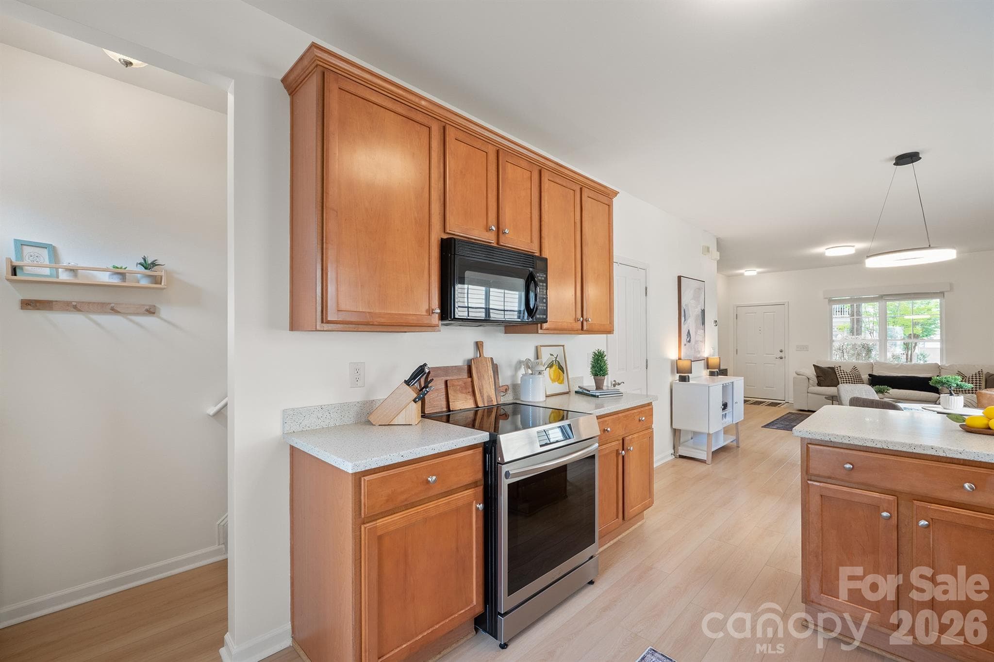 Stairway to primary suite is tucked away behind the kitchen - 14525 Holly Springs Drive, Huntersville
