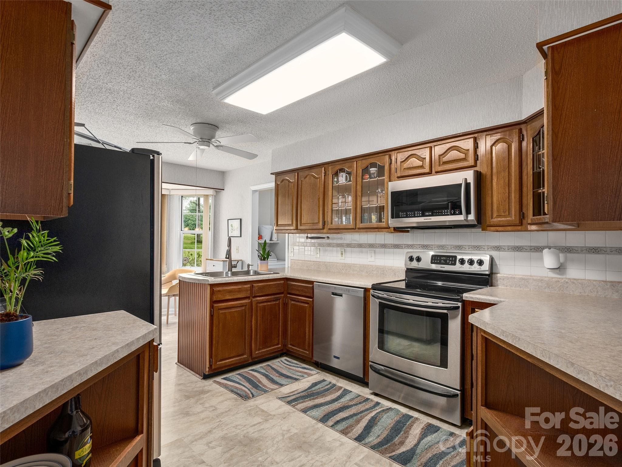 Kitchen with abundant wood cabinetry, generous counter space, and natural light. - 5 St Andrews Drive, Etowah