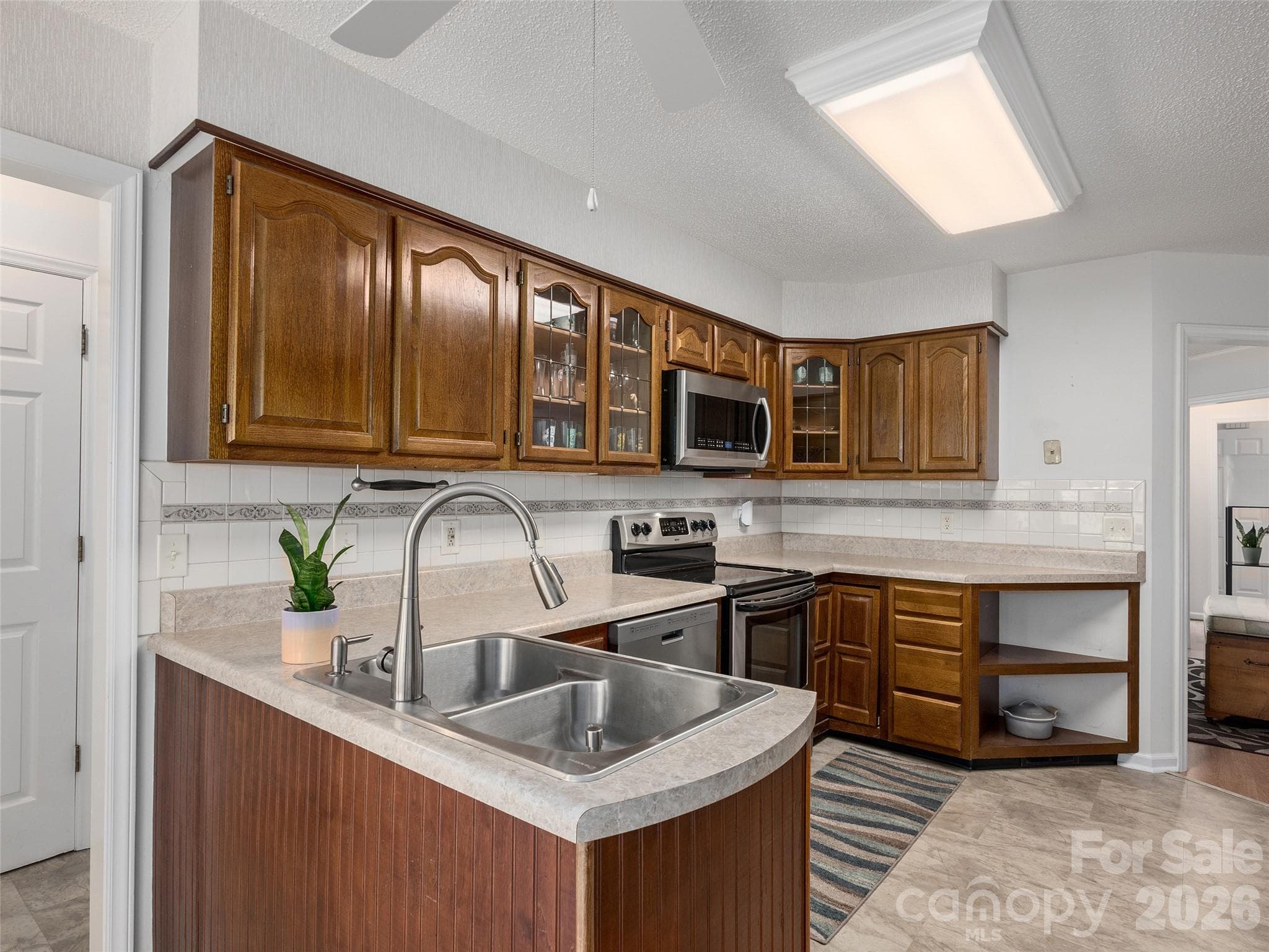 Spacious kitchen provides excellent workspace, storage, and an easy connection to the adjoining living areas. - 5 St Andrews Drive, Etowah