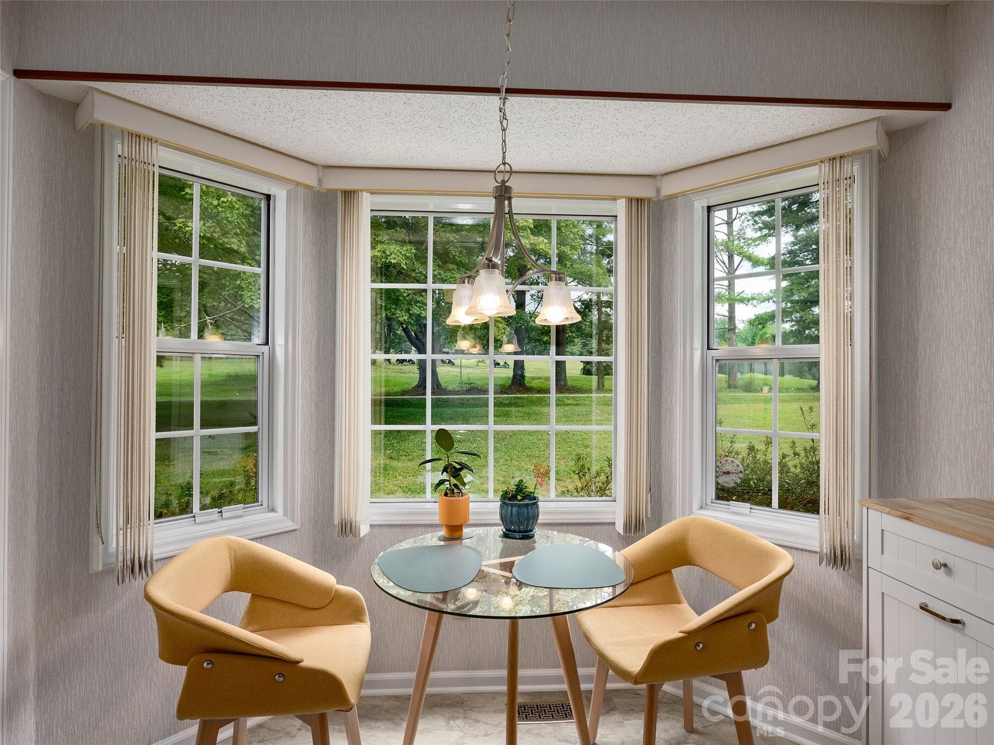 Bright breakfast area surrounded by windows creates an inviting spot for morning coffee or casual dining. - 5 St Andrews Drive, Etowah