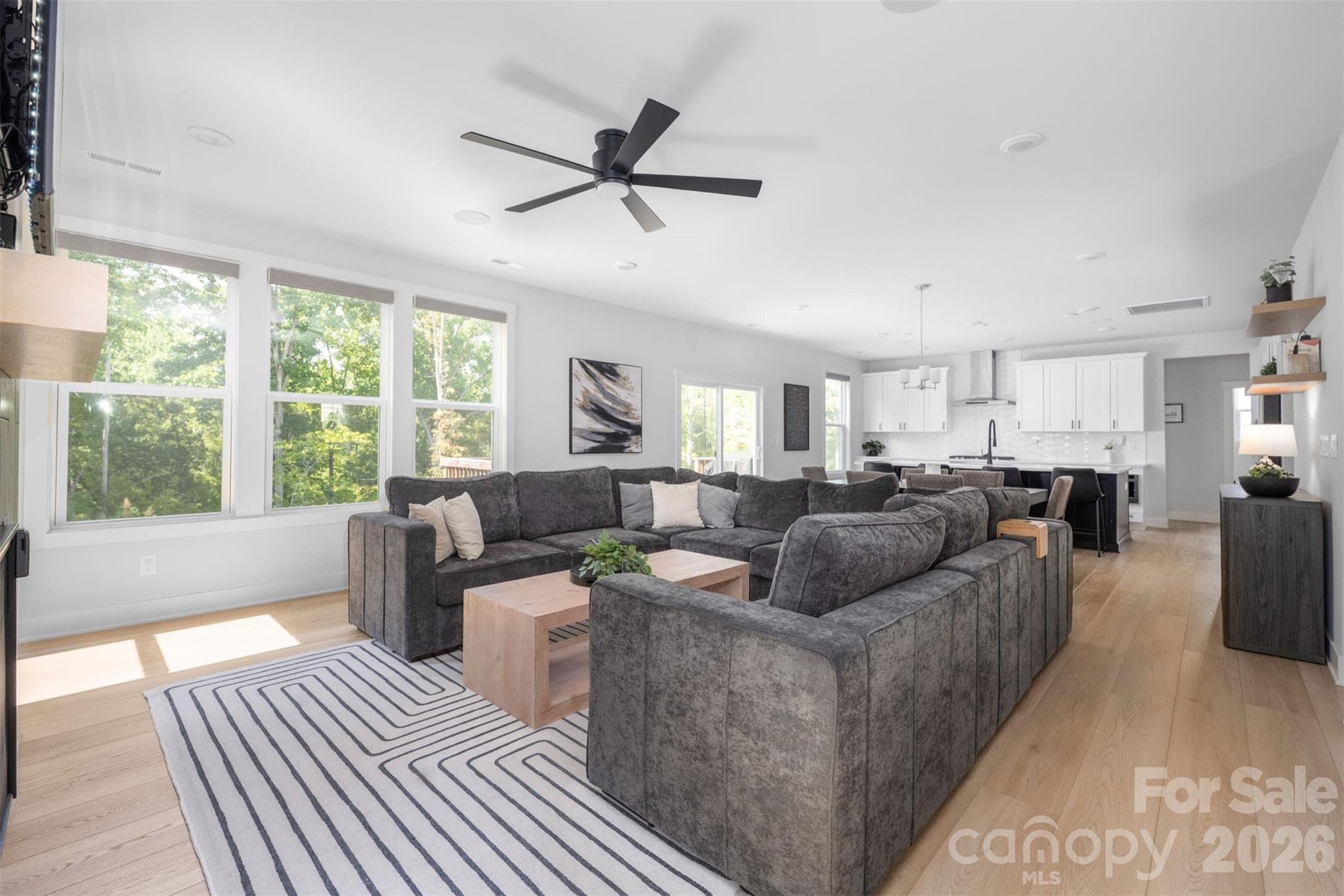 Great room with floor-to-ceiling tiled fireplace, open to the kitchen and breakfast area - 4320 Tournette Drive, Indian Land