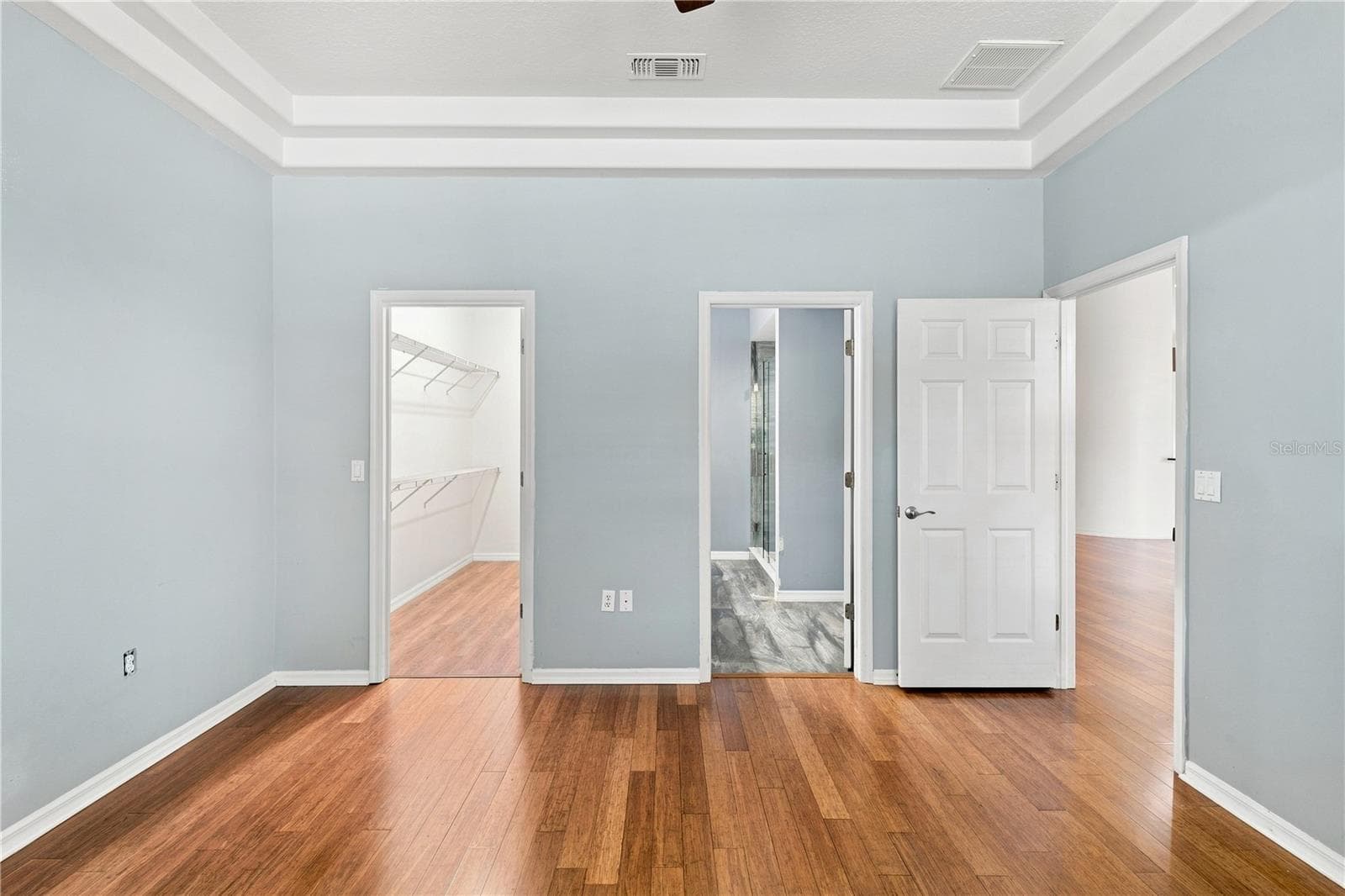 Primary bedroom bamboo floors - 10097 HOLLY BERRY DR, WEEKI WACHEE