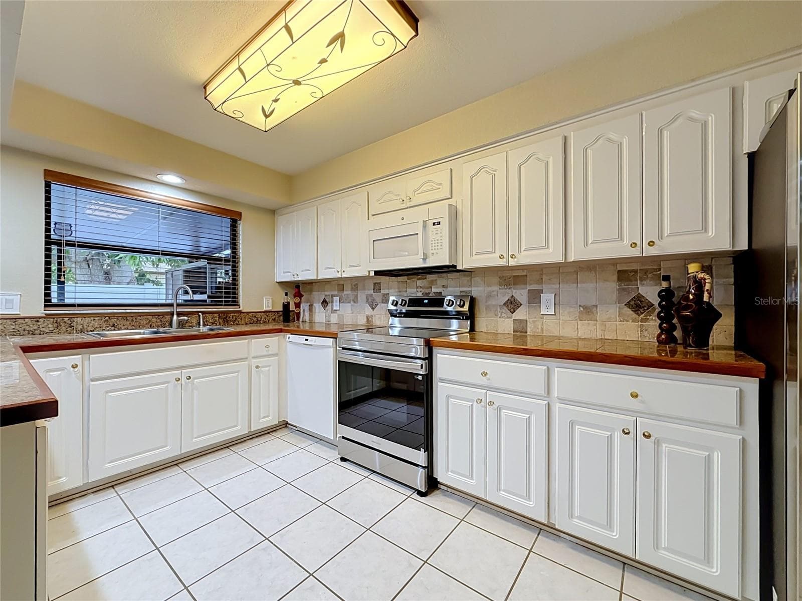White cabinetry in the Kitchen - 8830 DR MARTIN LUTHER KING JR ST N #UNIT 2B, ST PETERSBURG