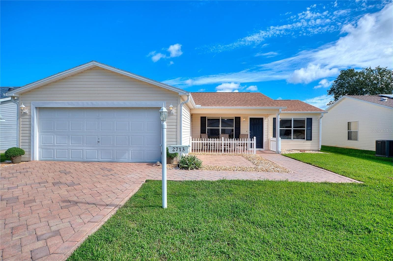 Paver driveway, full two-car garage and a welcoming covered front porch. - 2713 DE LA ROSA ST, THE VILLAGES