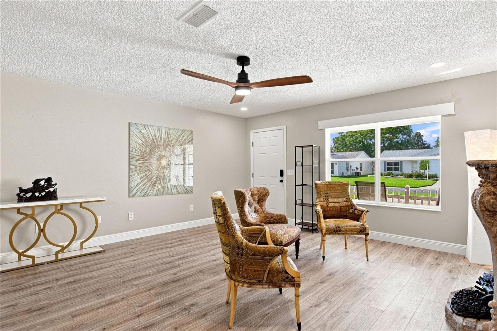 A large front window brings natural light into the spacious living room. - 2713 DE LA ROSA ST, THE VILLAGES