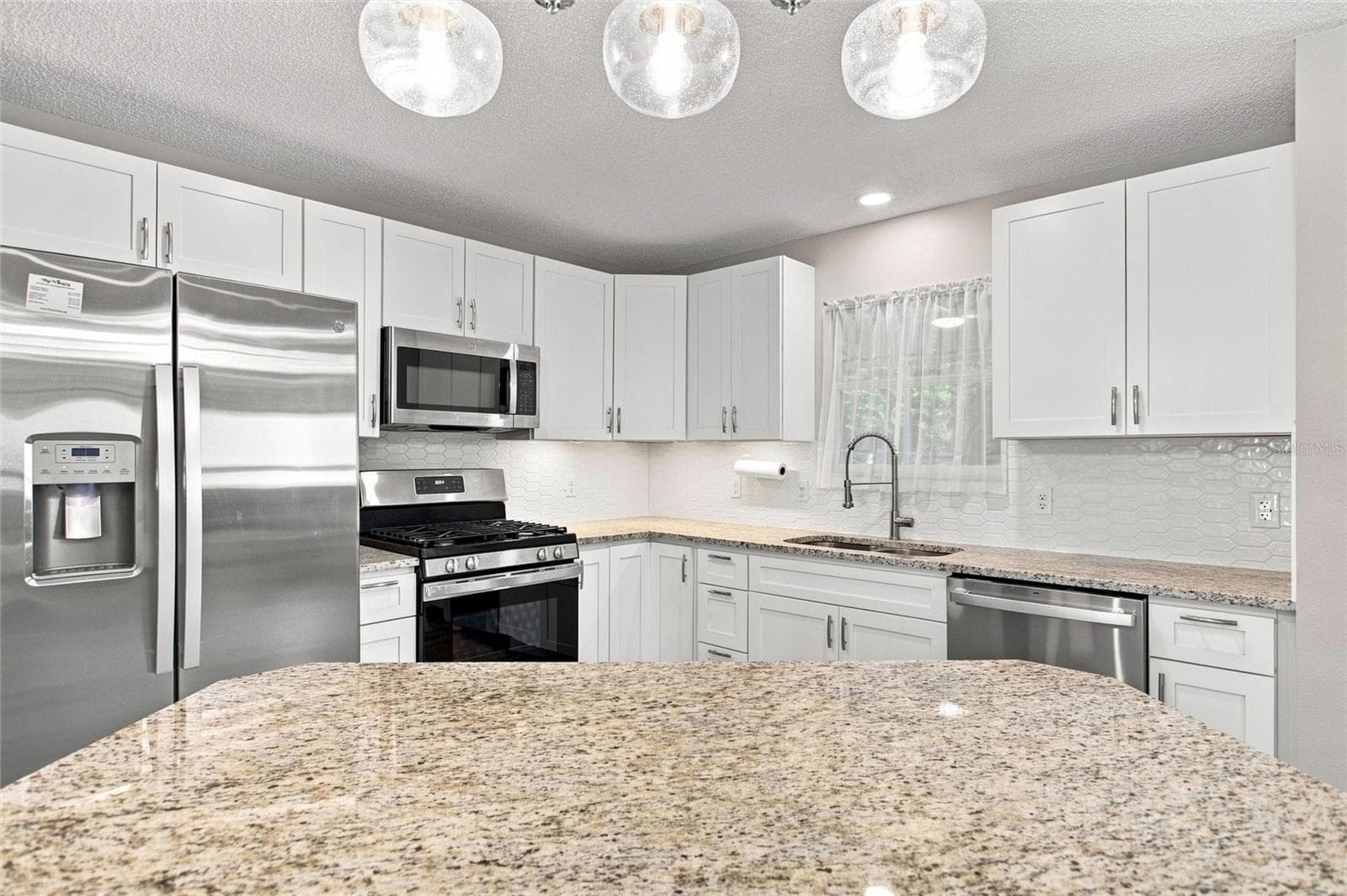 A gas range and generous granite counter space make meal preparation a pleasure. - 2713 DE LA ROSA ST, THE VILLAGES