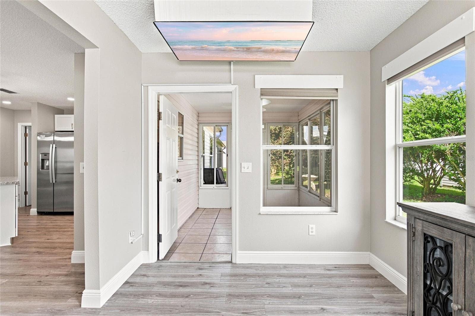 Florida room connects to the enclosed lanai, creating a natural flow between relaxation spaces. - 2713 DE LA ROSA ST, THE VILLAGES