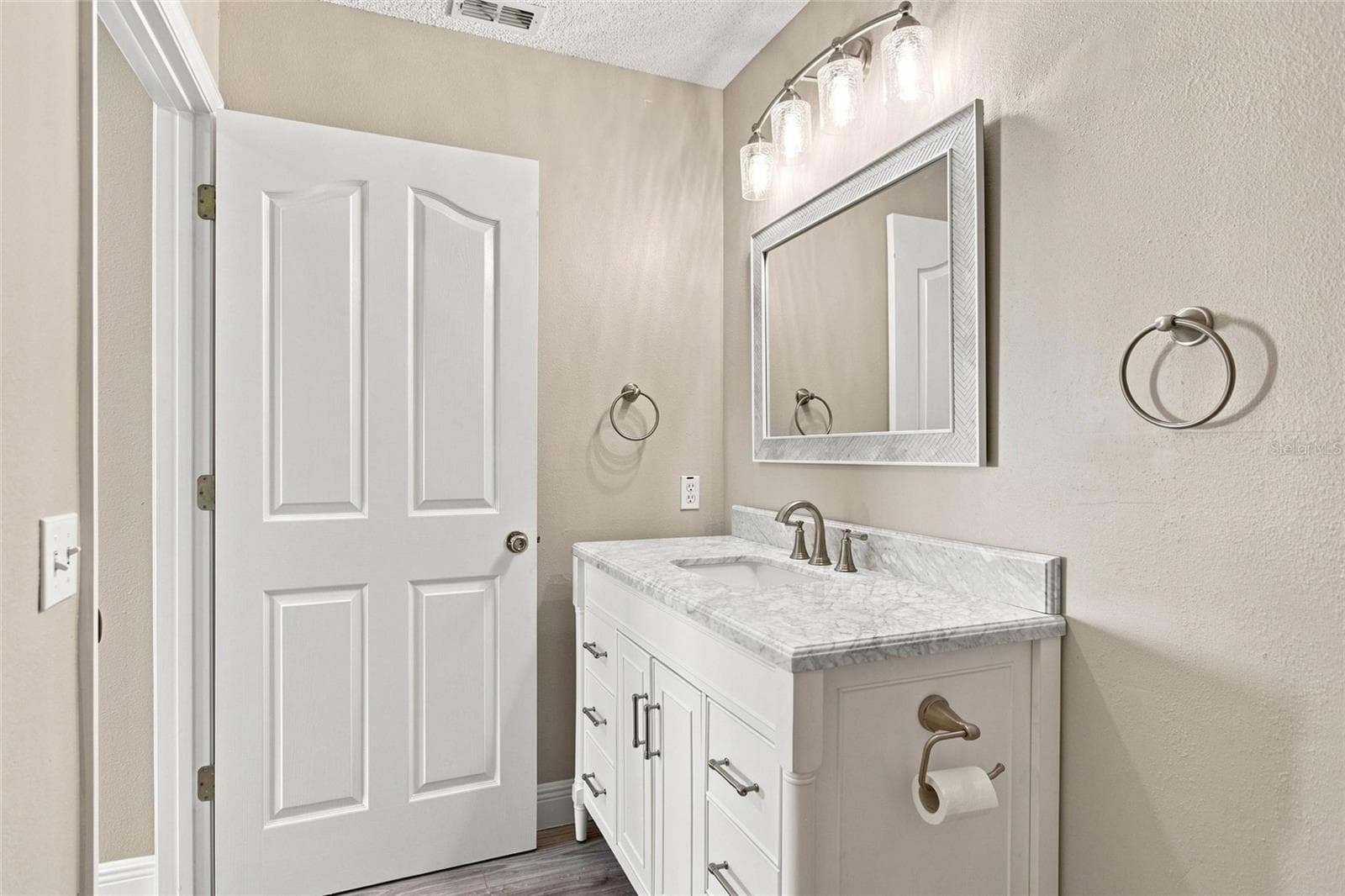 White vanity with cabinet and drawer storage keeps daily essentials organized. - 2713 DE LA ROSA ST, THE VILLAGES