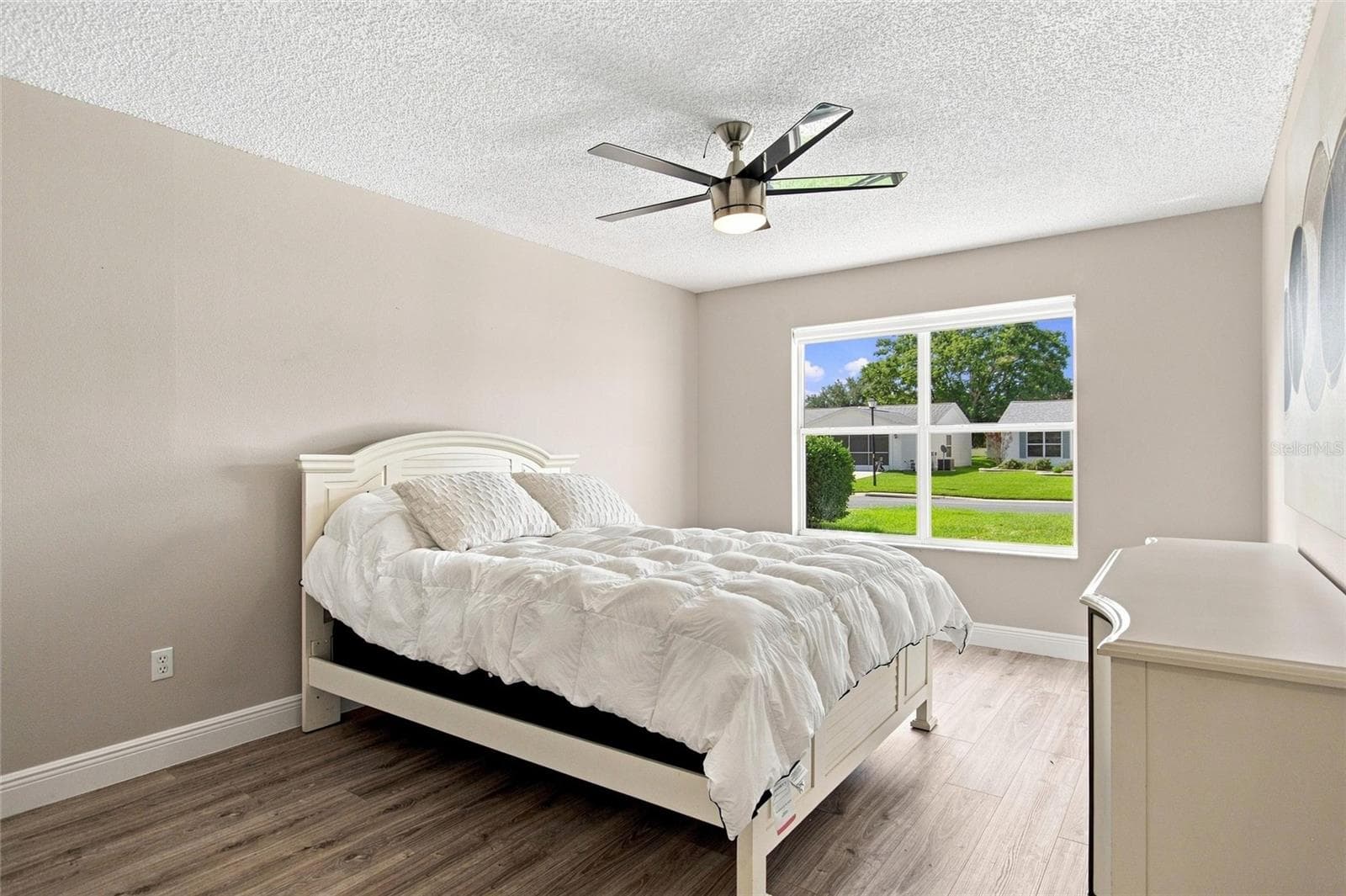 Spacious guest bedroom with natural light, neutral finishes and luxury vinyl plank flooring. - 2713 DE LA ROSA ST, THE VILLAGES