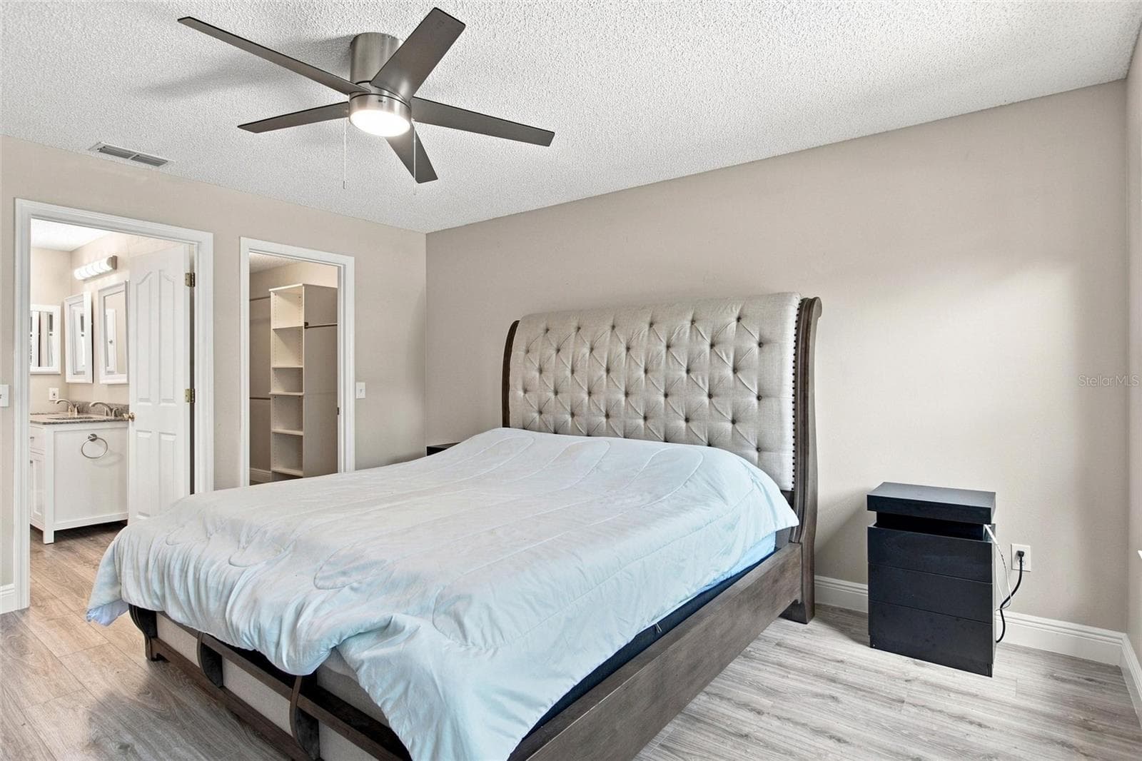 Primary suite includes an adjoining bathroom and a walk-in closet. - 2713 DE LA ROSA ST, THE VILLAGES