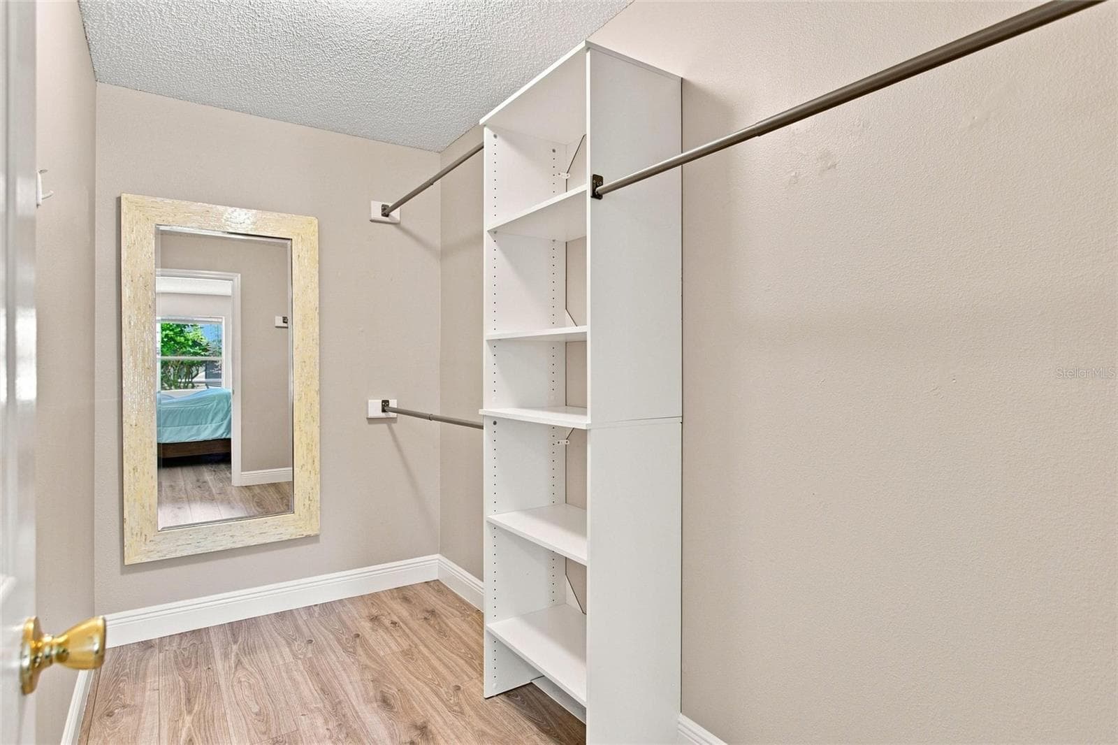 Primary walk-in closet includes shelving and hanging space to keep clothing organized. - 2713 DE LA ROSA ST, THE VILLAGES