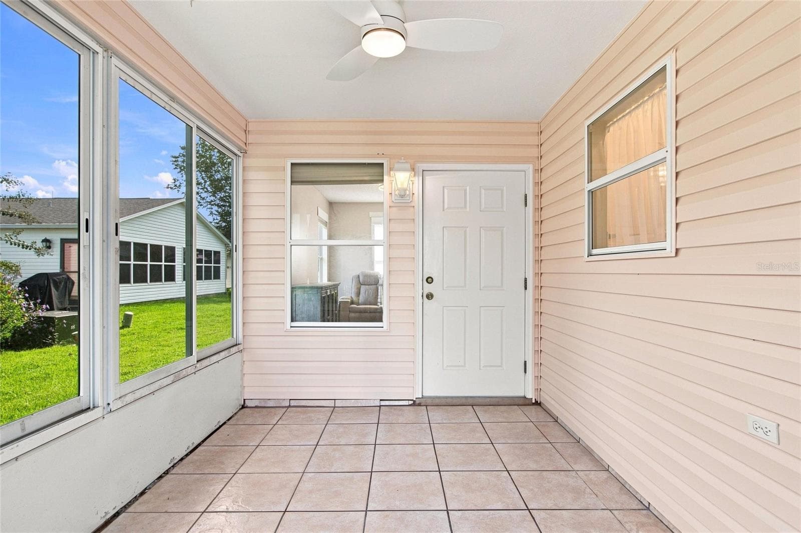 Enjoy morning coffee in the enclosed lanai, complete with a ceiling fan and access to the home. - 2713 DE LA ROSA ST, THE VILLAGES