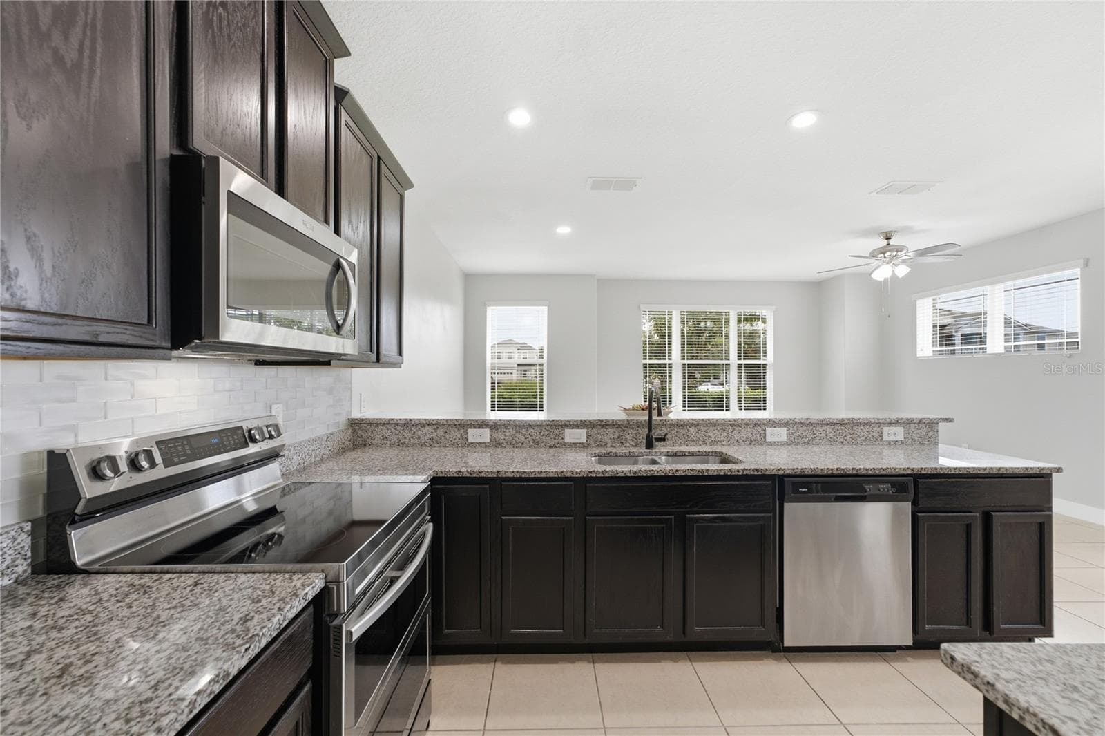 Open-concept kitchen overlooking the bright and spacious living area—perfect for entertaining. - 2615 GIARDINO LOOP, KISSIMMEE