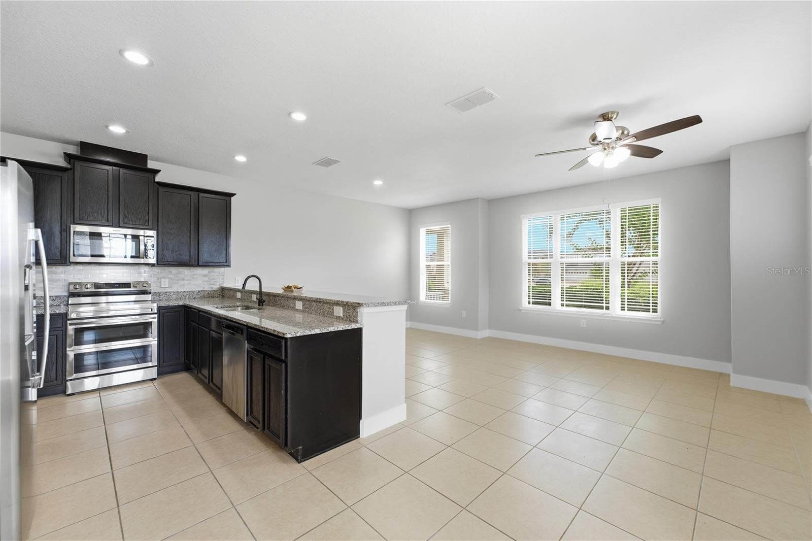 Bright, spacious open-concept kitchen and living area with recessed LED lighting. - 2615 GIARDINO LOOP, KISSIMMEE